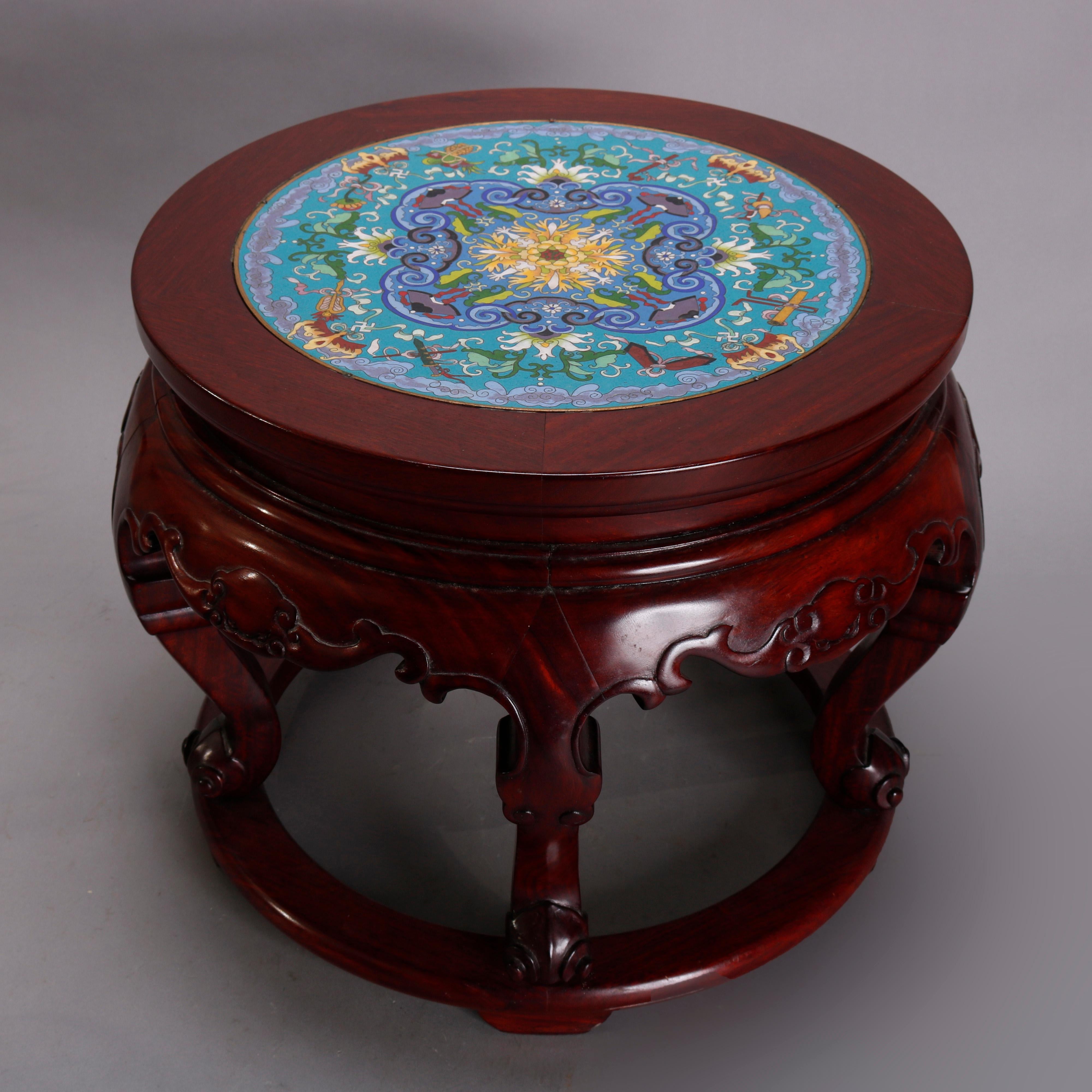 A vintage Chinese low table offers Cloisonne inset top having floral motif seated in carved mahogany base with shaped skirt raised on cabriole legs, 20th century

Measures: 13.5