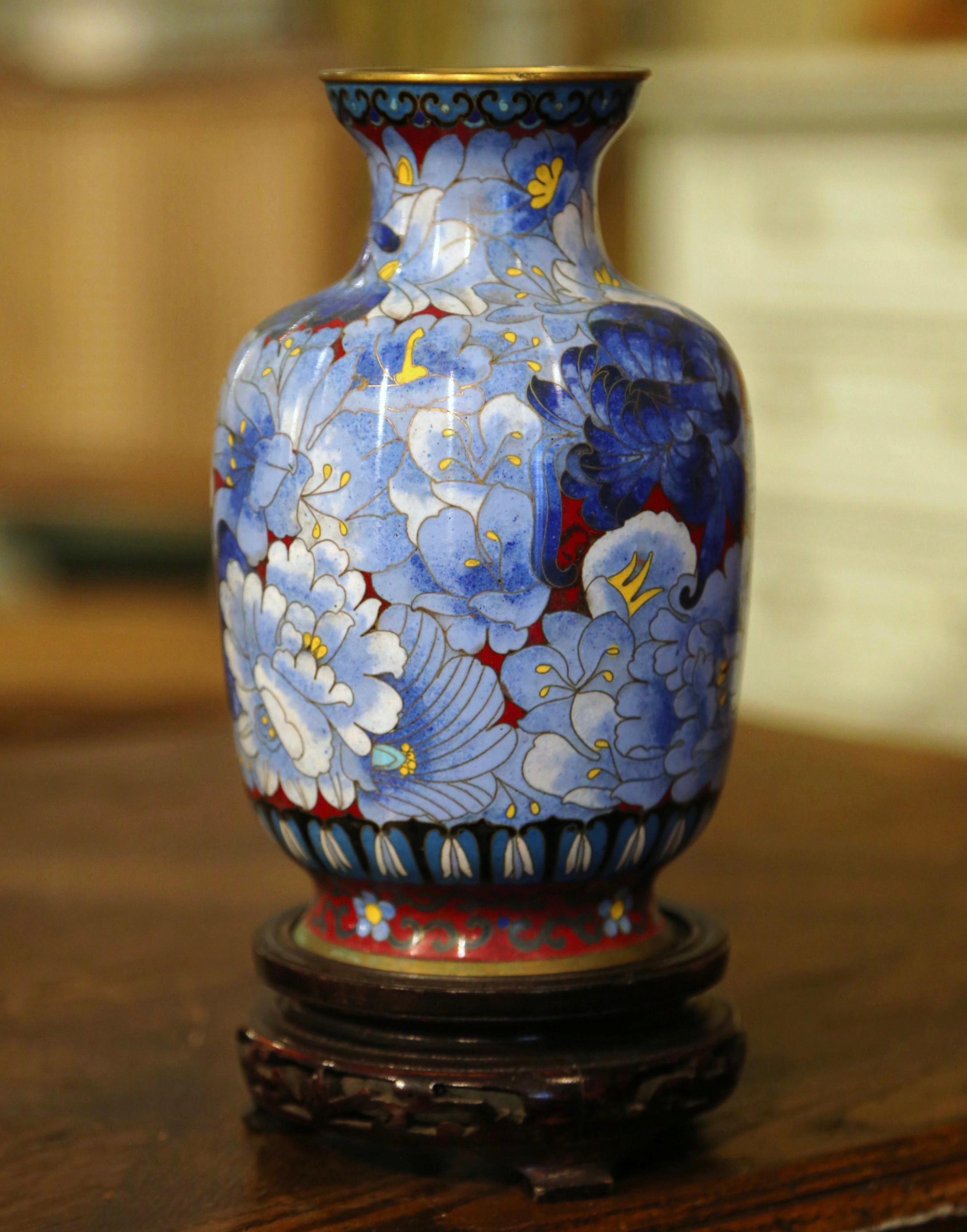 Decorate a table or a buffet with this colorful baluster vase. Created in China circa 1980, the vase features floral motifs in the cloisonné technique (decorative work in which enamel, glass, or gemstones are separated by strips of flattened wire