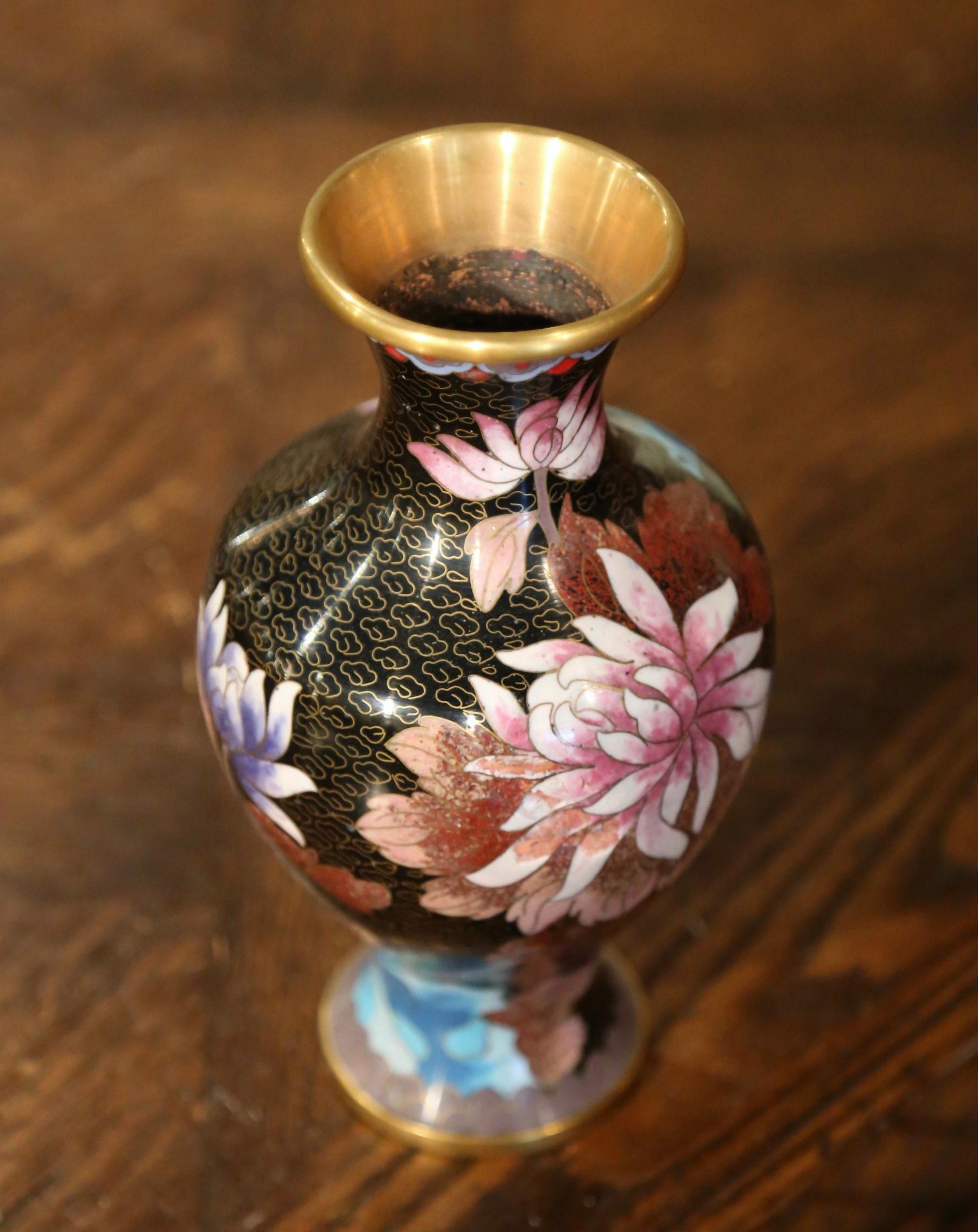 Decorate a table or a buffet with this colorful baluster vase. Created in China circa 1980, the vase features floral and leaf motifs in the cloisonné technique (decorative work in which enamel, glass, or gemstones are separated by strips of