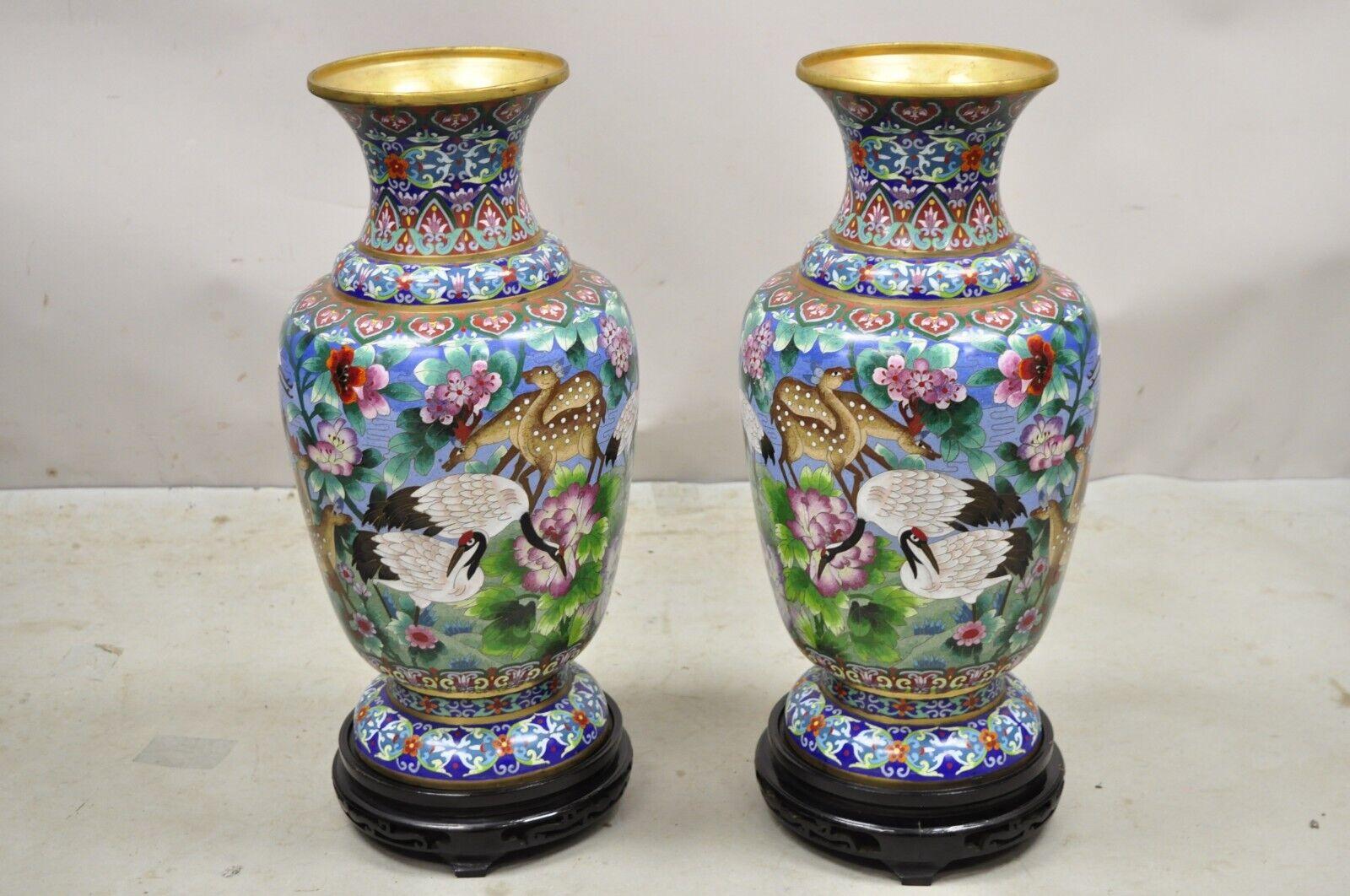 Vintage Chinese Cloisonné Porcelain Enamel Figural Crane and Deer Vase - a Pair. Item features a removable carved wooden base, crane birds, deer, and flowers throughout, large impressive size, great style and form. Circa Early to Mid 20th Century.