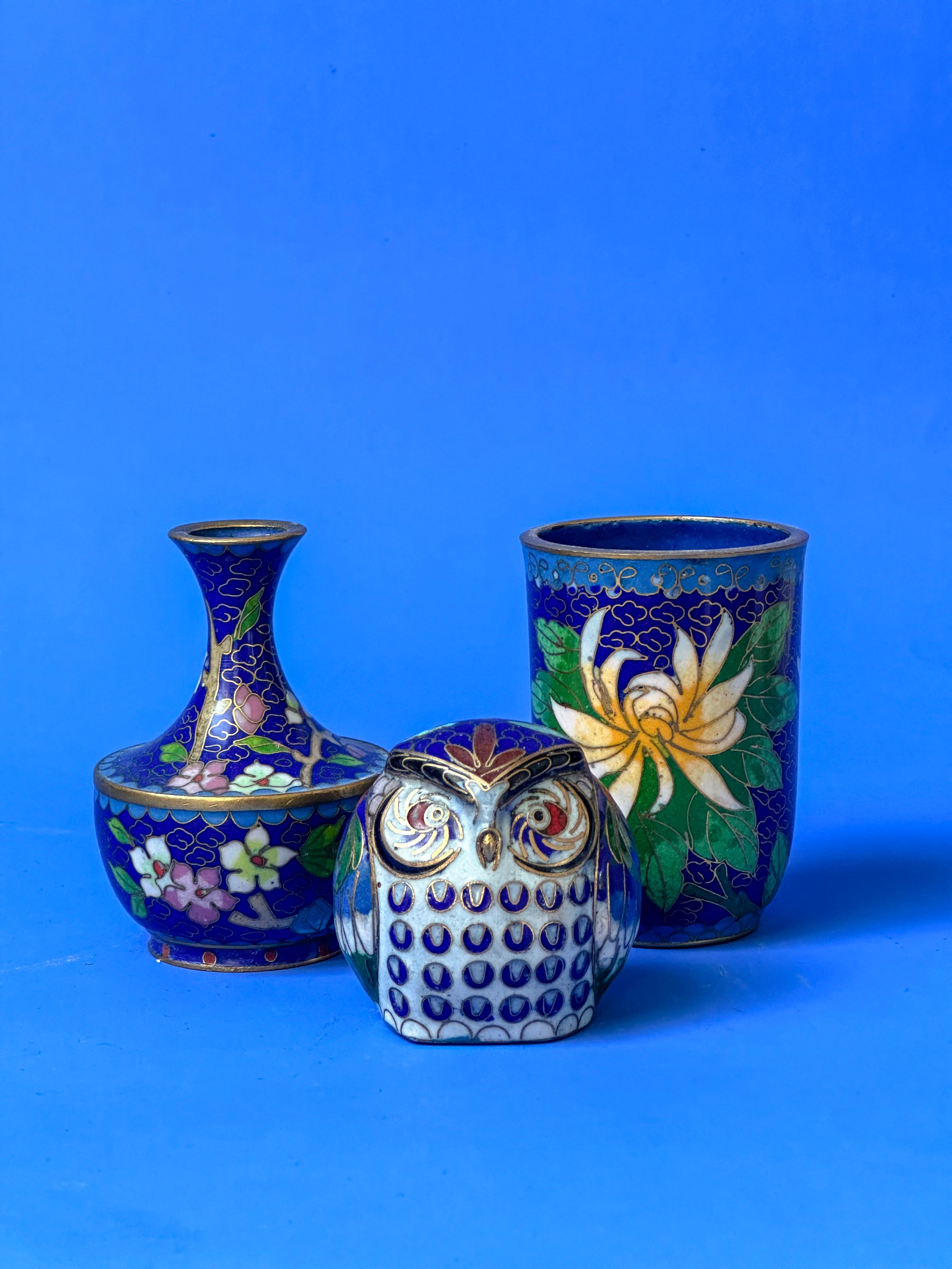 This vintage Chinese cloisonné collection features a trio of miniature blue ornaments, with each exuding its own unique charm and delicate design. The set includes a small vase, a small beaker, and a small owl ornament, all crafted from brass. These