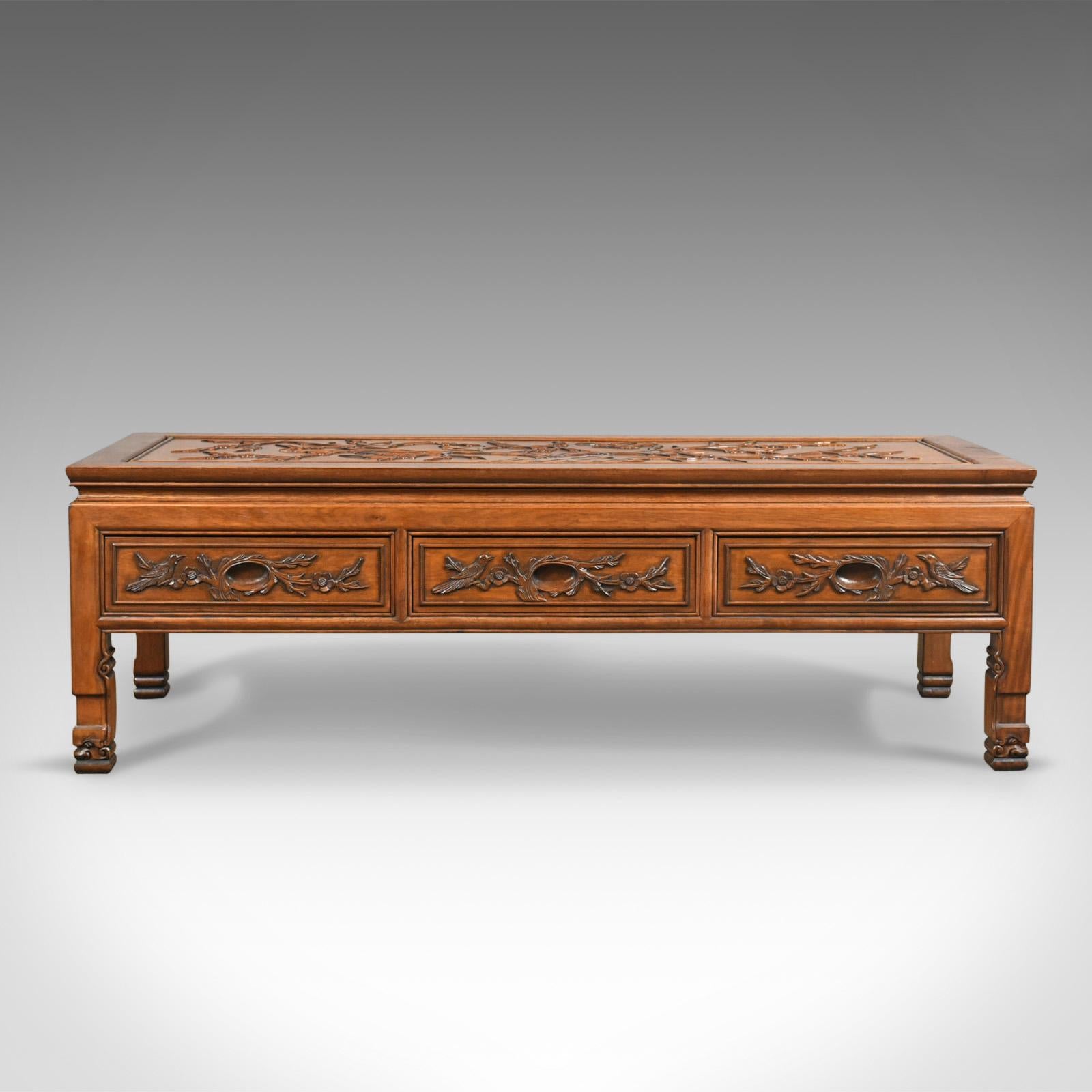This is a vintage Chinese coffee table, a low, three drawer, and carved oriental cabinet dating to the late Art Deco period, circa 1940.

A most pleasing low table presented in good antique condition
Beautifully relief carved to the tabletop and