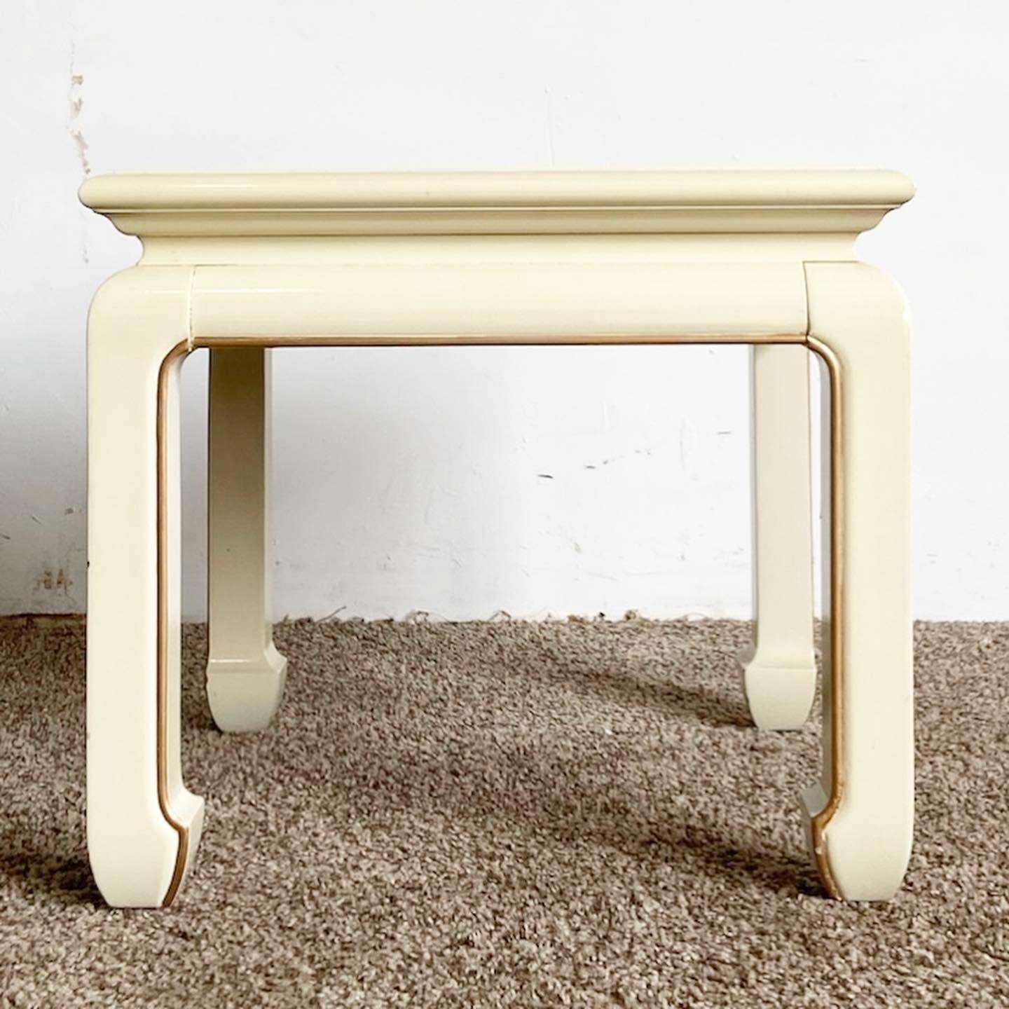 Exceptional vintage Chinese wooden square side table. Features a cream lacquered finish with hand painted gold and floral accents.
