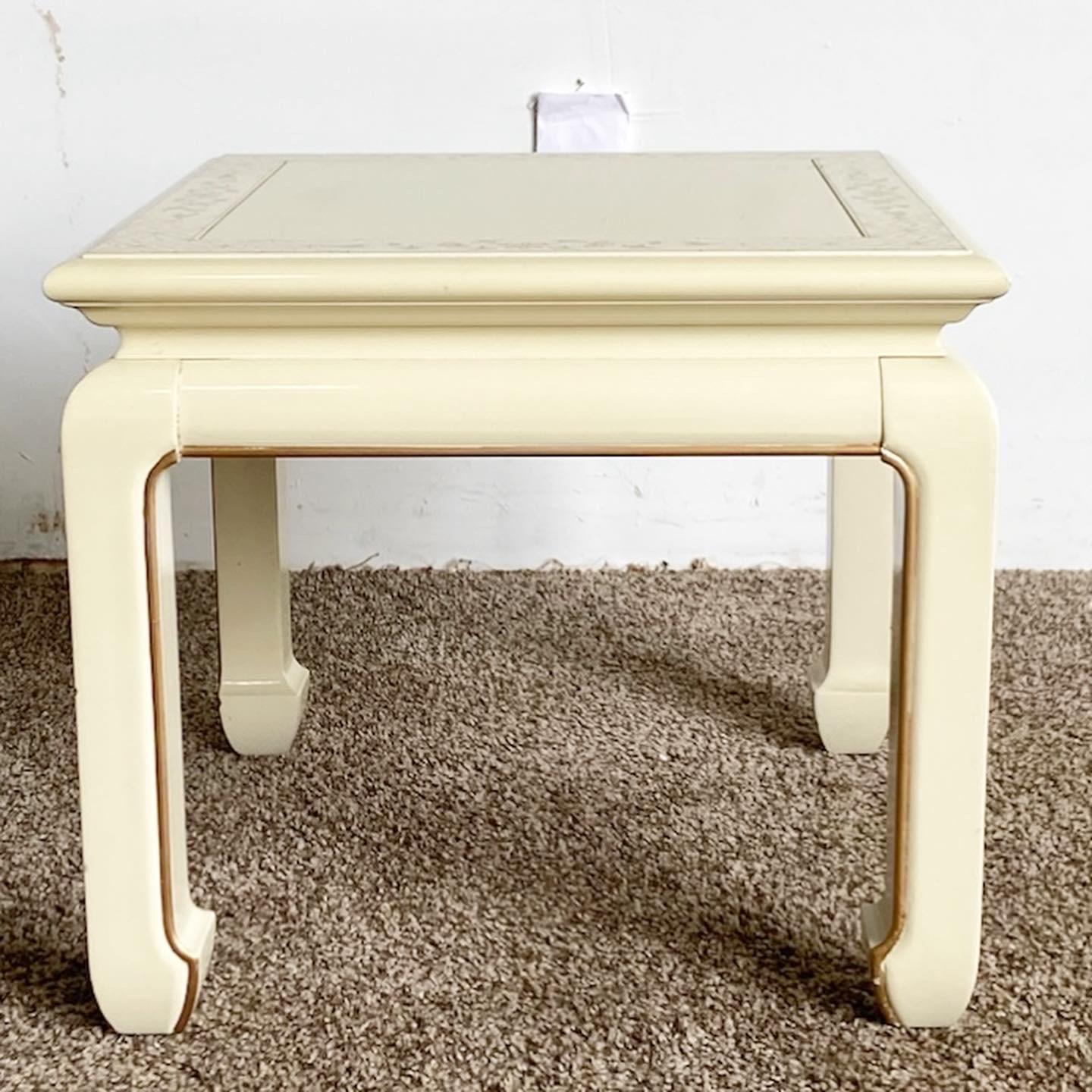 Exceptional vintage Chinese wooden square side table. Features a cream lacquered finish with hand painted gold and floral accents.