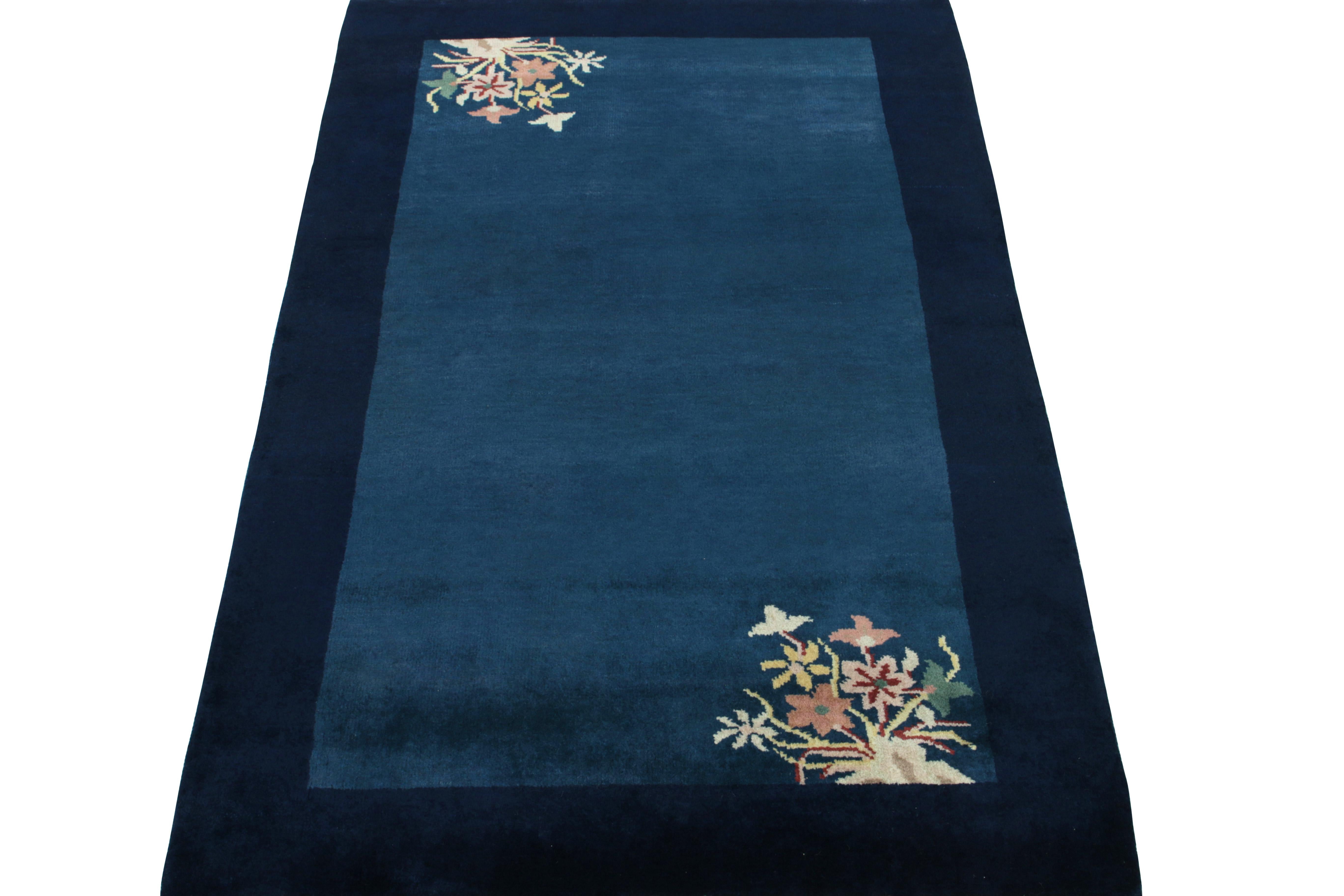Hand-knotted in luscious wool, a 3x5 vintage art deco rug carrying Chinese sensibilities of the 1920s. The deep blue tones marry the sheen of wool for an alluring luster in a healthy pile, with gentle light and dark spots in blue on the open field