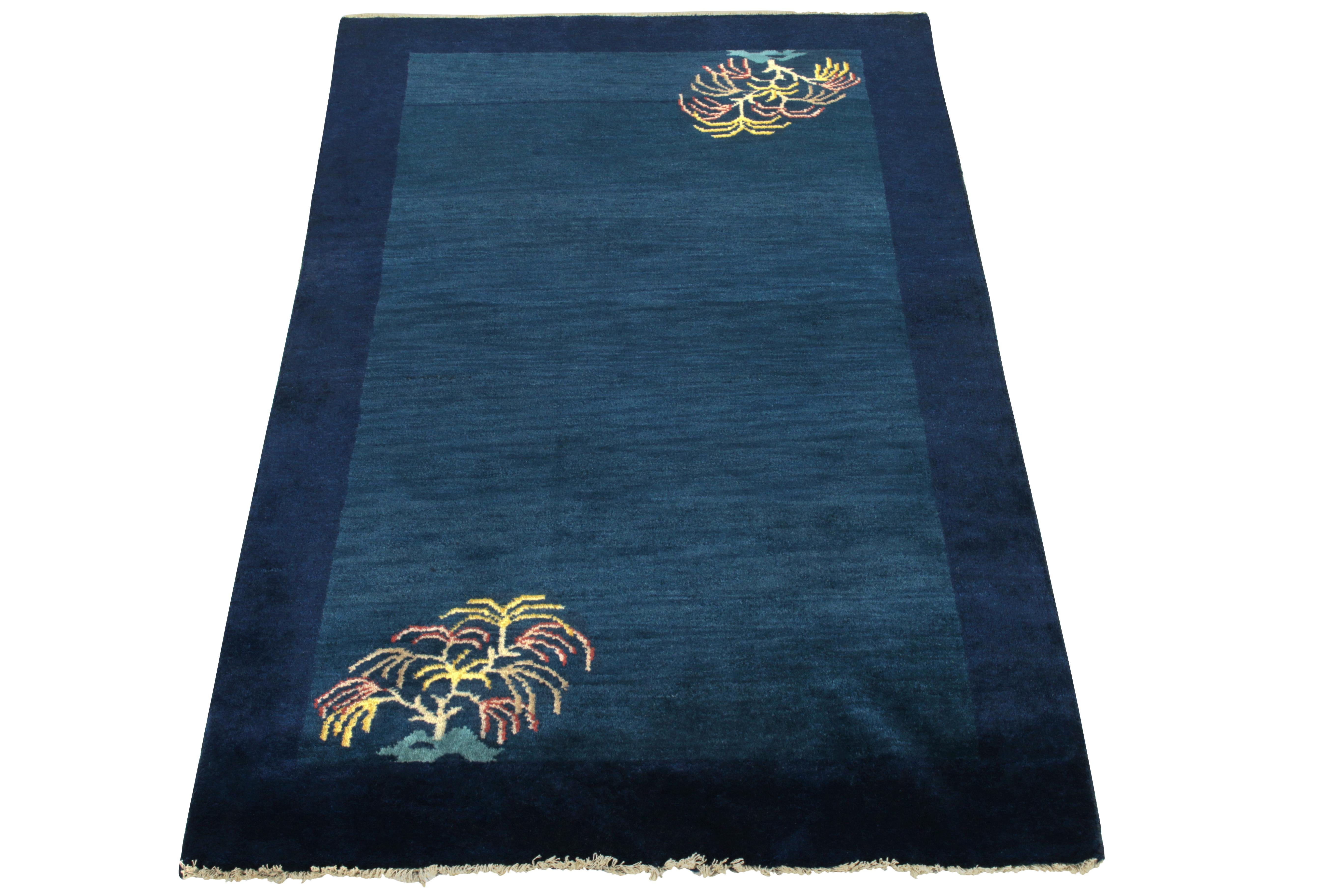 Celebrating Oriental style in a minimalist approach, this 2x5 vintage ode to Chinese art deco rugs of the 1920s features tree branches in teal, golden, light red & light blue across diagonal inner corners. Subtly representing a garden theme on an