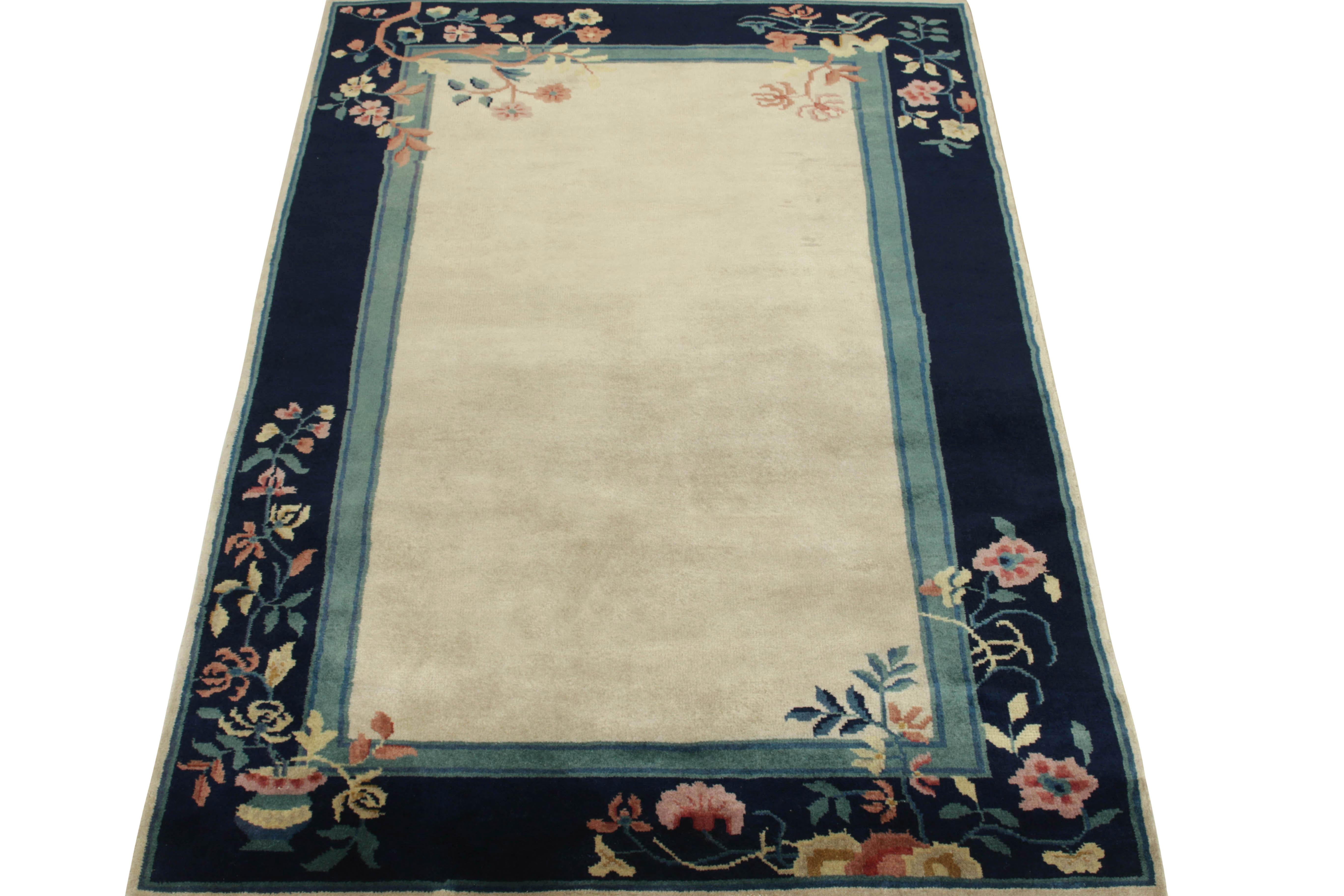 Joining Rug & Kilim’s Antique & Vintage selections, a hand-knotted vintage rug embracing Chinese art deco style of the 1920s—particularly emphasizing floral patterns & decorative imagery lining the corners of deep blue & teal toned borders in