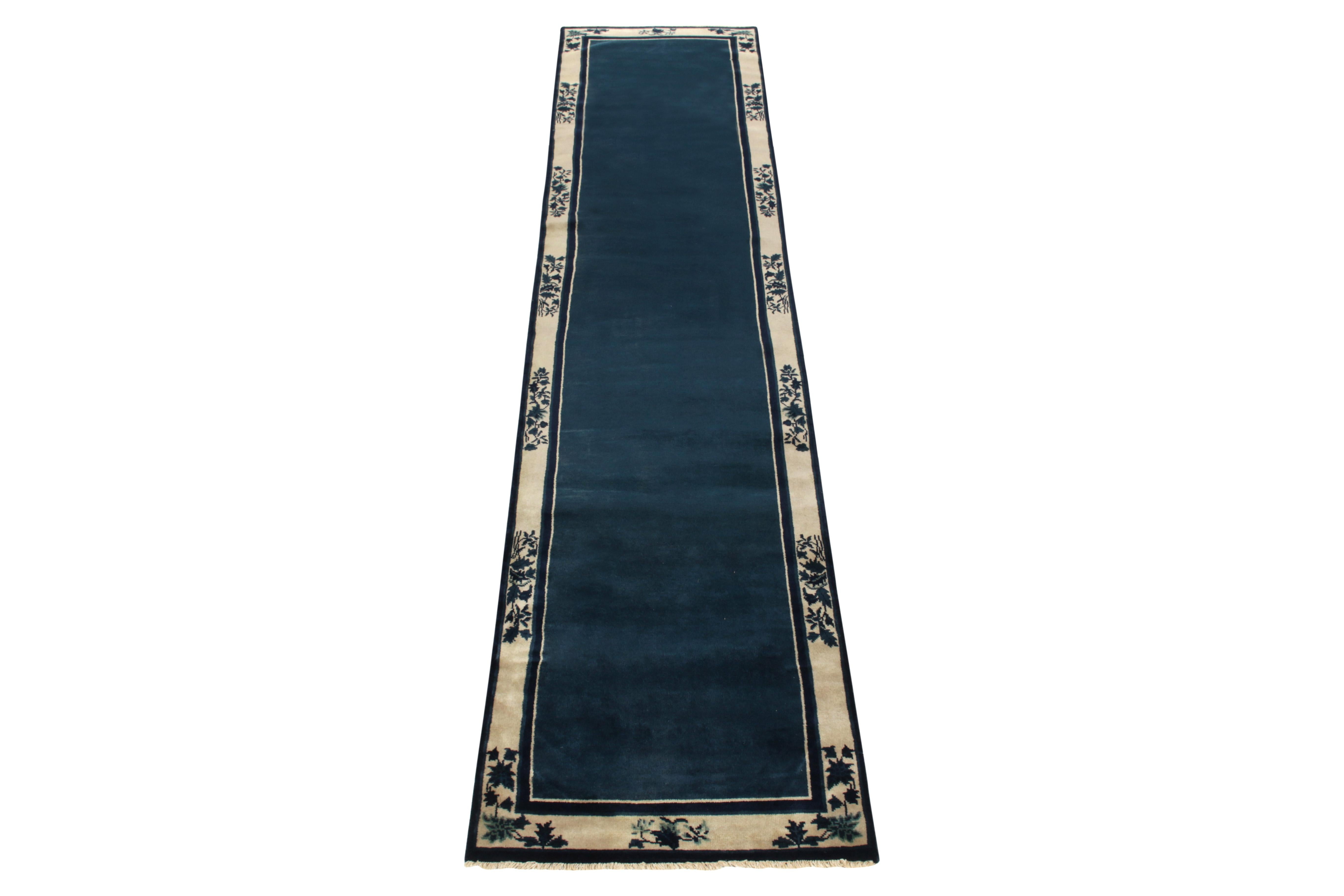 A 2x12 wool hand-knotted vintage runner connoting Chinese art deco sensibilities of the 1920s, from the newest line joining Rug & Kilim’s Antique & Vintage collection. The clean blue open field enjoys light dark spots for an interesting visual