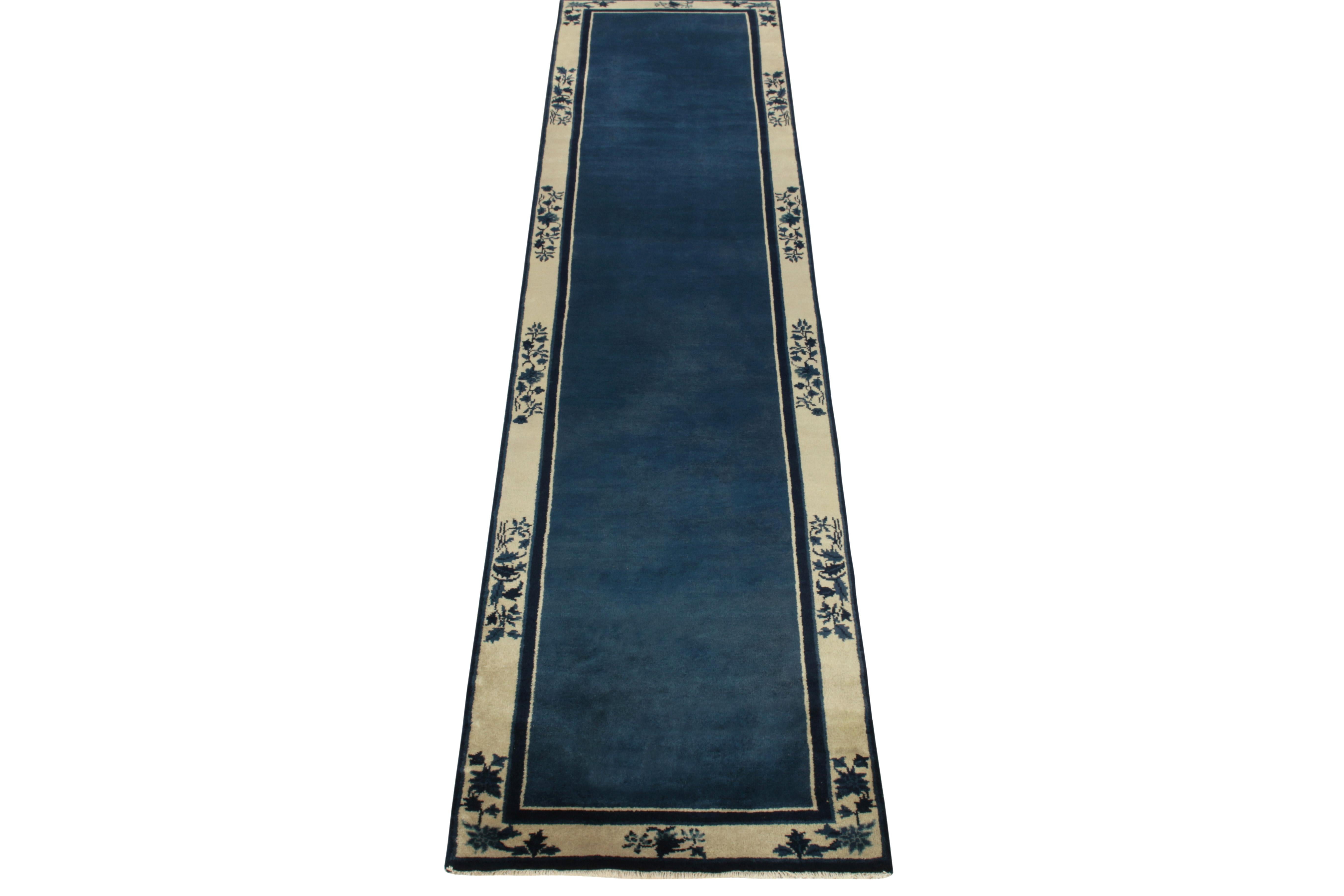 A hand-knotted wool vintage runner connoting Chinese art deco sensibilities inspired from the 1920s, joining Rug & Kilim’s latest classic collection. The clean blue open field enjoys light dark spots for an interesting visual appeal on scale further