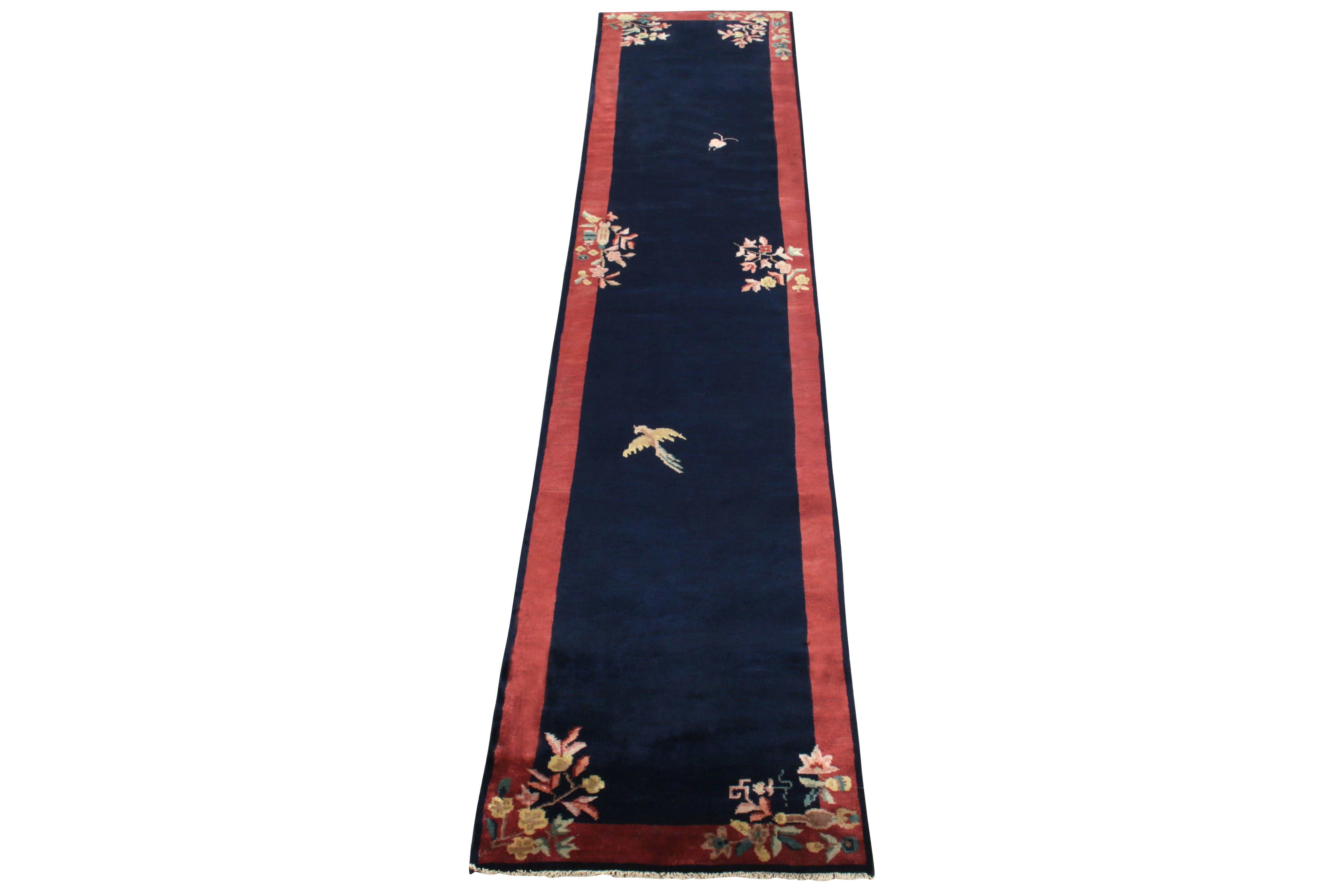 Hand-knotted in wool, a 2x11 ode to Chinese art deco rugs from our Antique & Vintage collection bearing classic sensibilities of the 1920s. This vintage rug enjoys a healthy pile with mild light and dark spots on the deep blue field for a luxurious