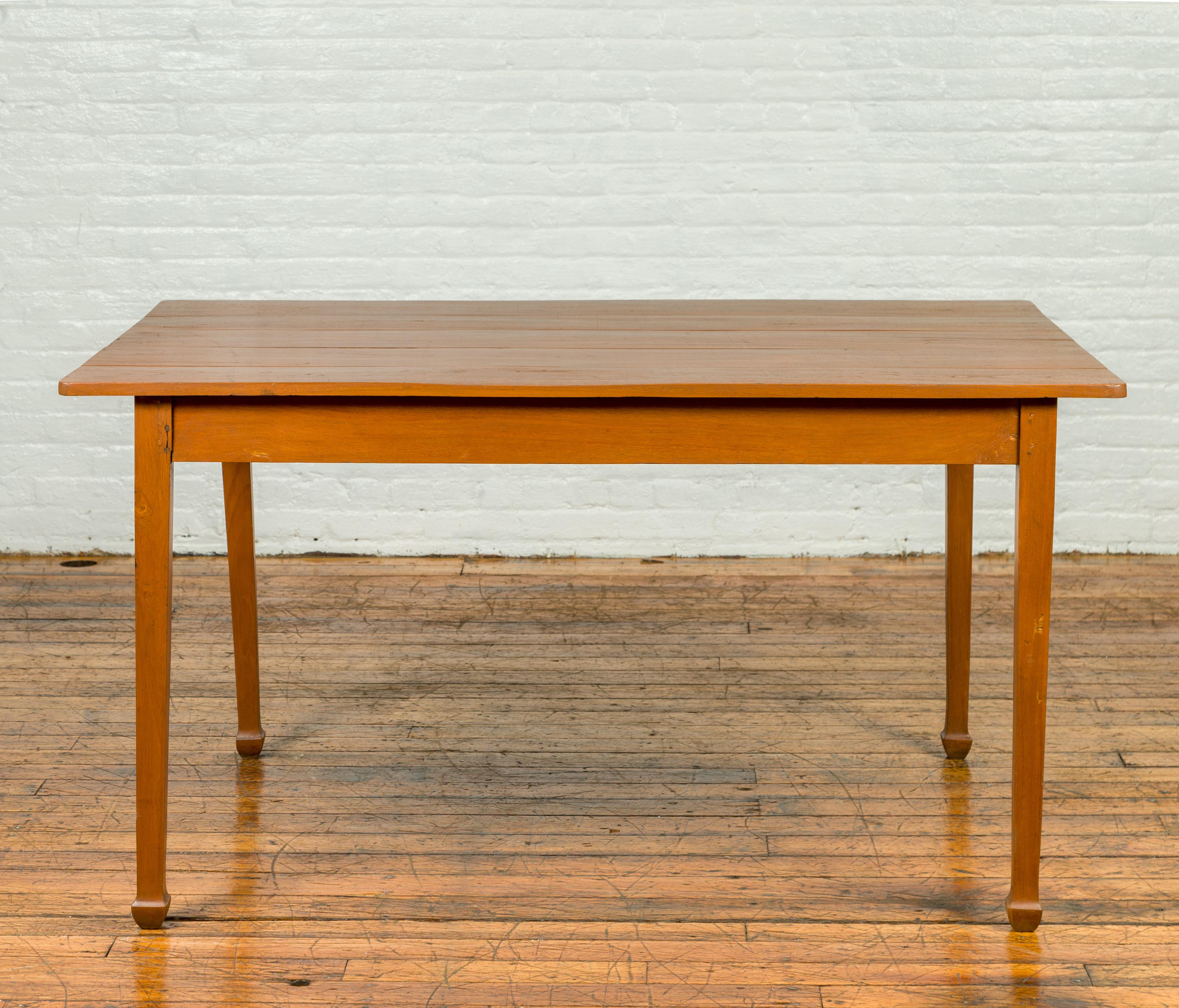 A vintage dining table from the mid-20th century, with classic, simple design and spade feet. Add a touch of timeless elegance to your dining space with this vintage mid-20th century dining table. Crafted with a classic and simple design, this table