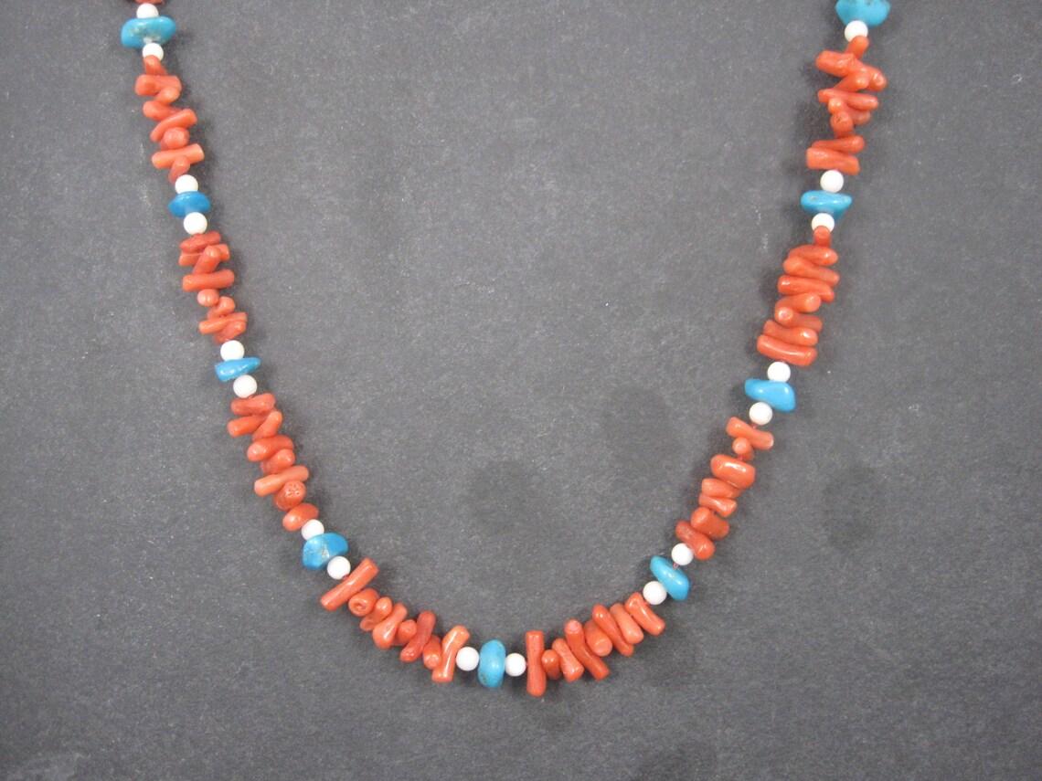 This gorgeous 1950s imported necklace features stunning genuine coral and turquoise beads.
The ornate clasp is 14k gold.

Measurements: 1/2 of an inch wide, 30 wearable inches
Weight: 53.1 grams

Clasp is marked 14K

Condition: Excellent