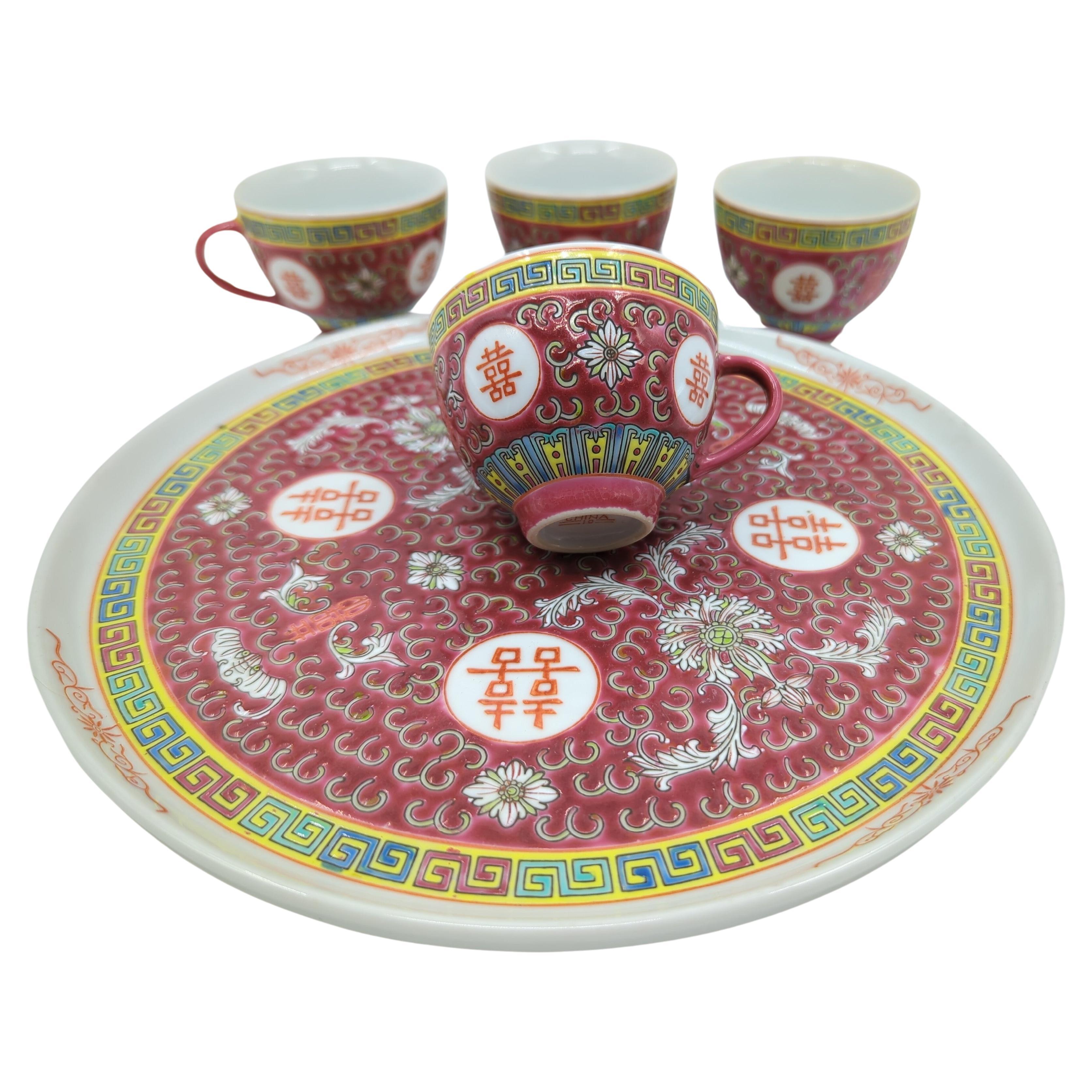 We are honored to offer this exceptional Chinese porcelain tea set, specifically designed for marriage ceremonies and originating from Jingdezhen's Factory 10, circa 1970s. Comprising four tea cups and a coordinating circular tray, this set is a
