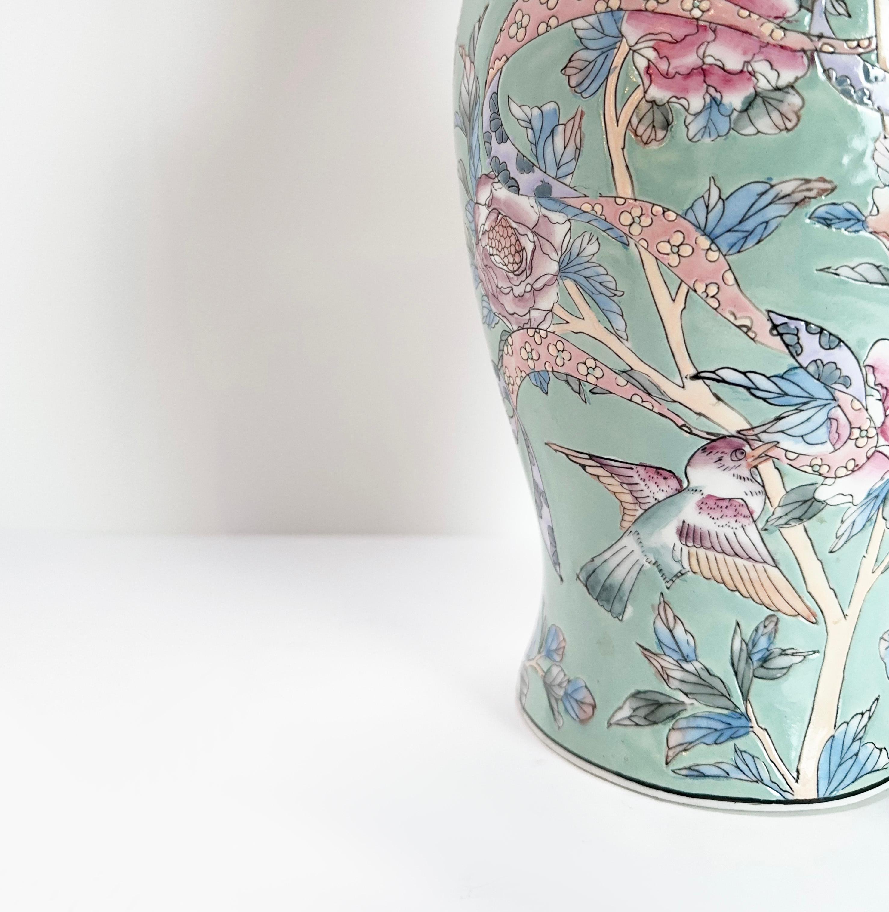 This stunning baluster vase, originating from China and likely crafted in the 1980s, is a splendid example of the Famille Rose porcelain tradition. Though the maker's stamp is present, the artisan's identity remains a mystery, adding to its