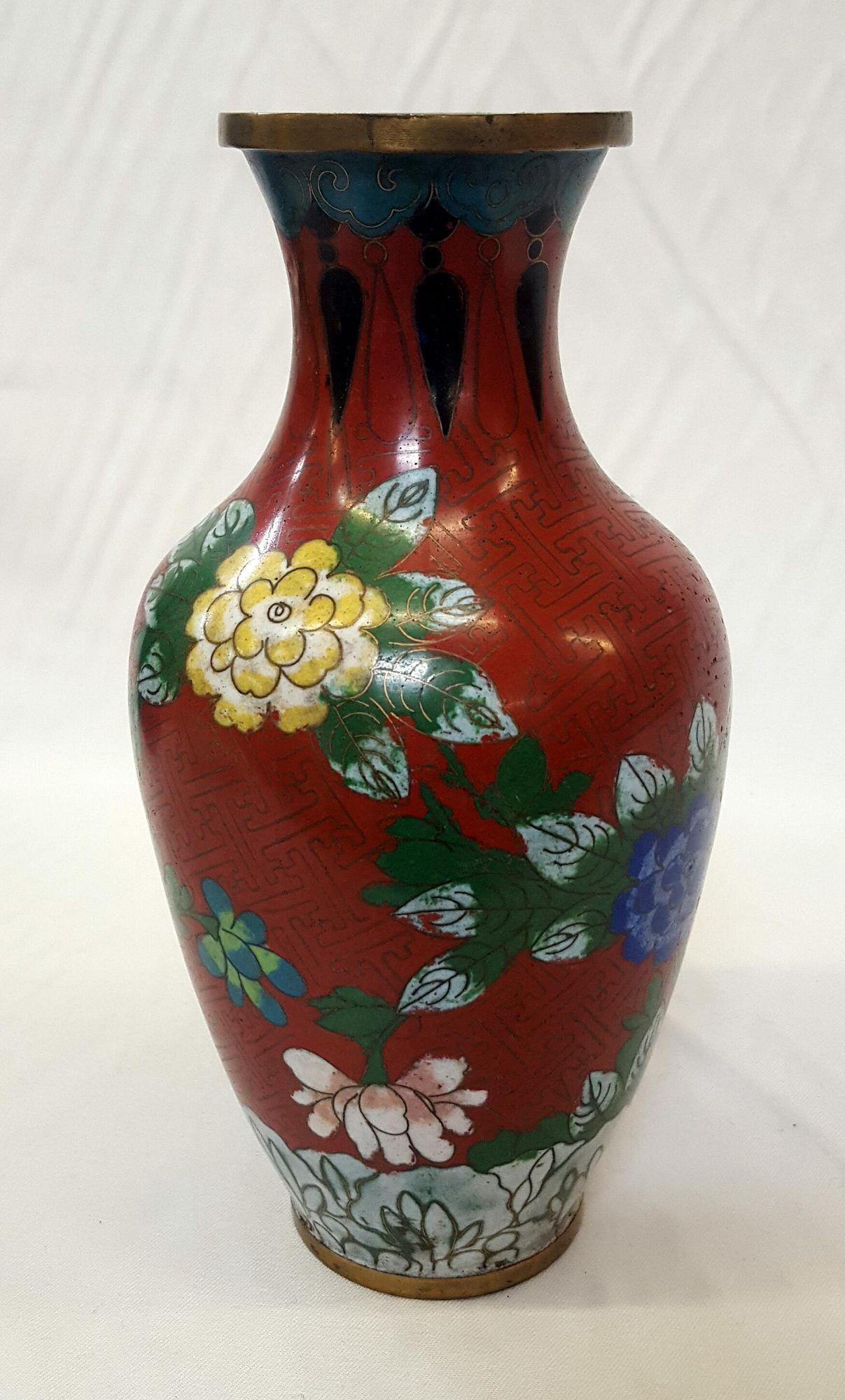 Chinese floral champleve vase enamel-over-brass Vintage.

Origin: China
Dimensions: 9-1/4 inches tall X 5 inches wide X 5 inches deep
Colors: Red, green, black, violet, pink, blue, yellow and brass
Condition/Info: Vintage floral design Chinese