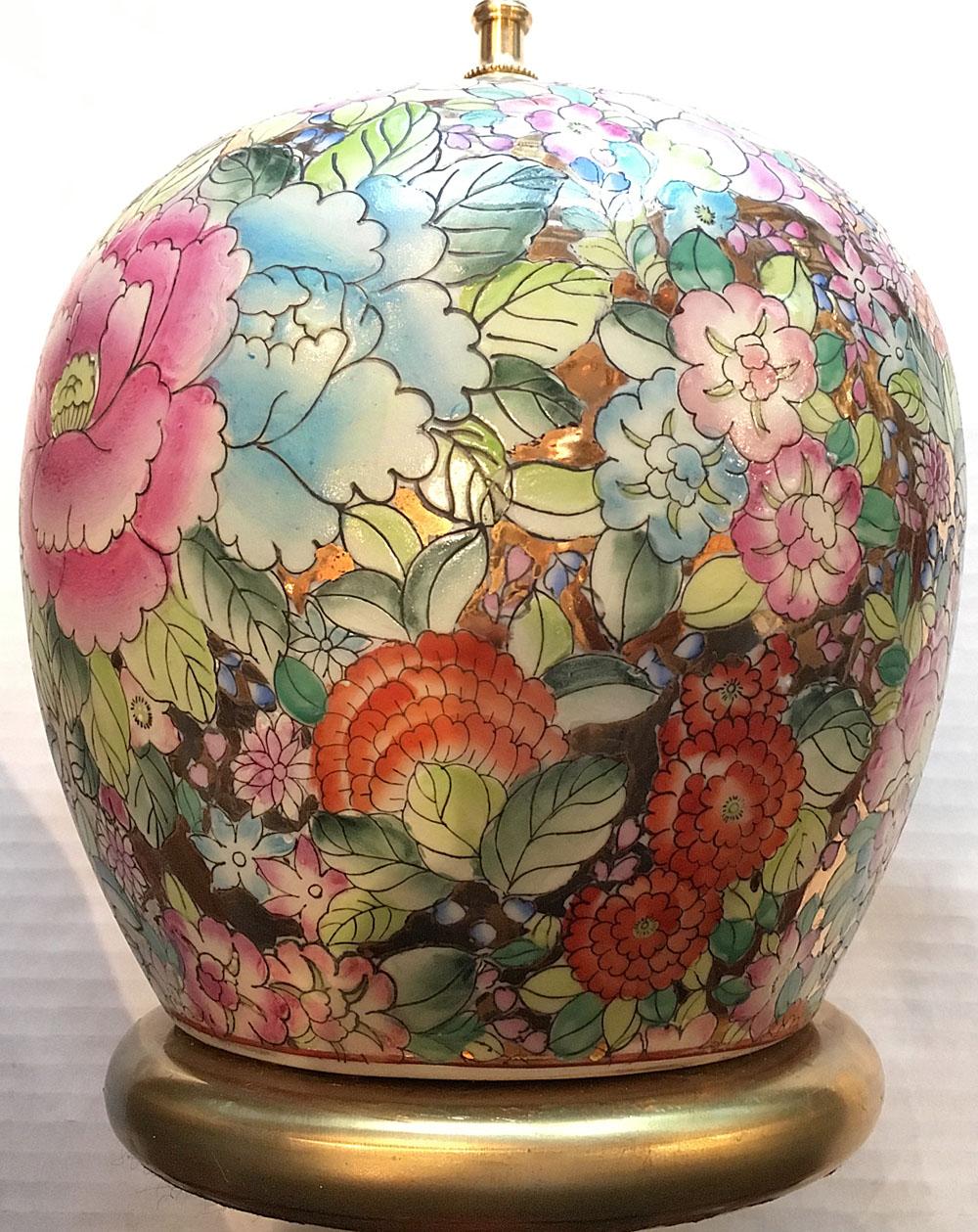 A circa 1950s Chinese porcelain table lamp with floral decoration on a gold background.