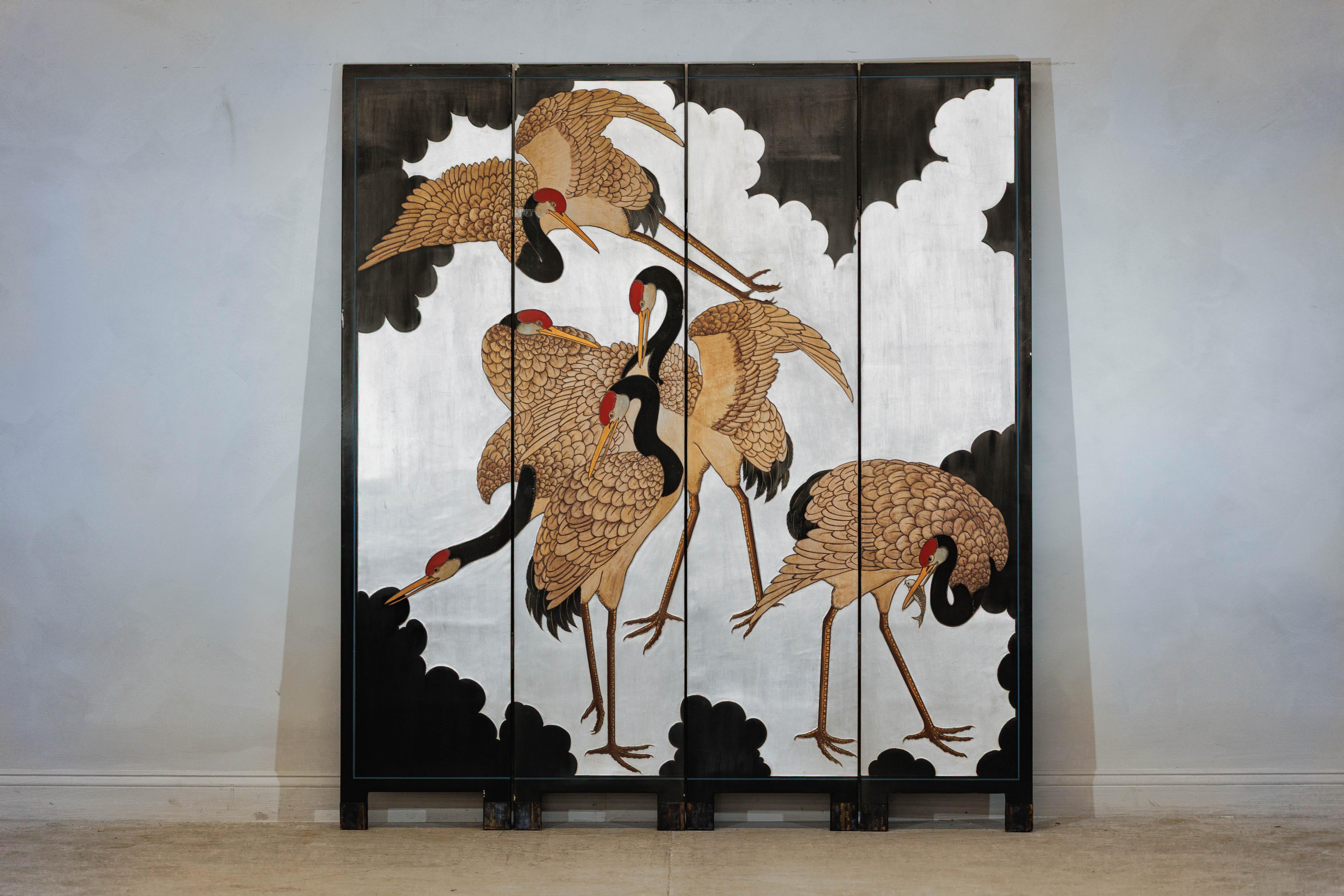 This vintage Chinese four-panel screen features a striking depiction of red-crowned cranes set against a luminous silver-colored ground. Rendered in a bold, stylized manner, the five cranes are arranged in a dynamic vertical composition—some