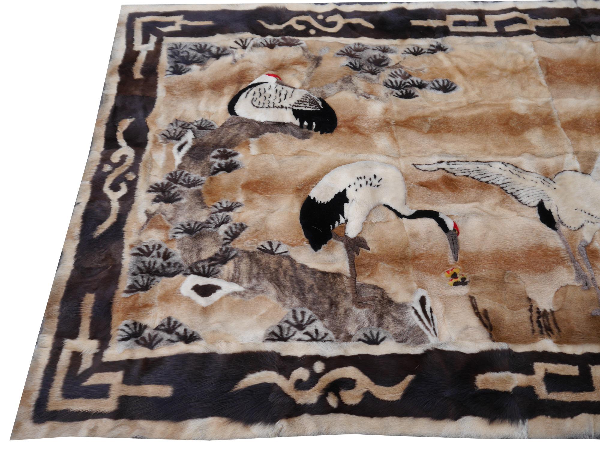 This rure vintage rug was made using different pieces of fur from goats and sheep. It was made in patchwork style like a quilt. The design is Art Deco style with a landscape and cranes. The condition of this wall hanging rug is excellent.