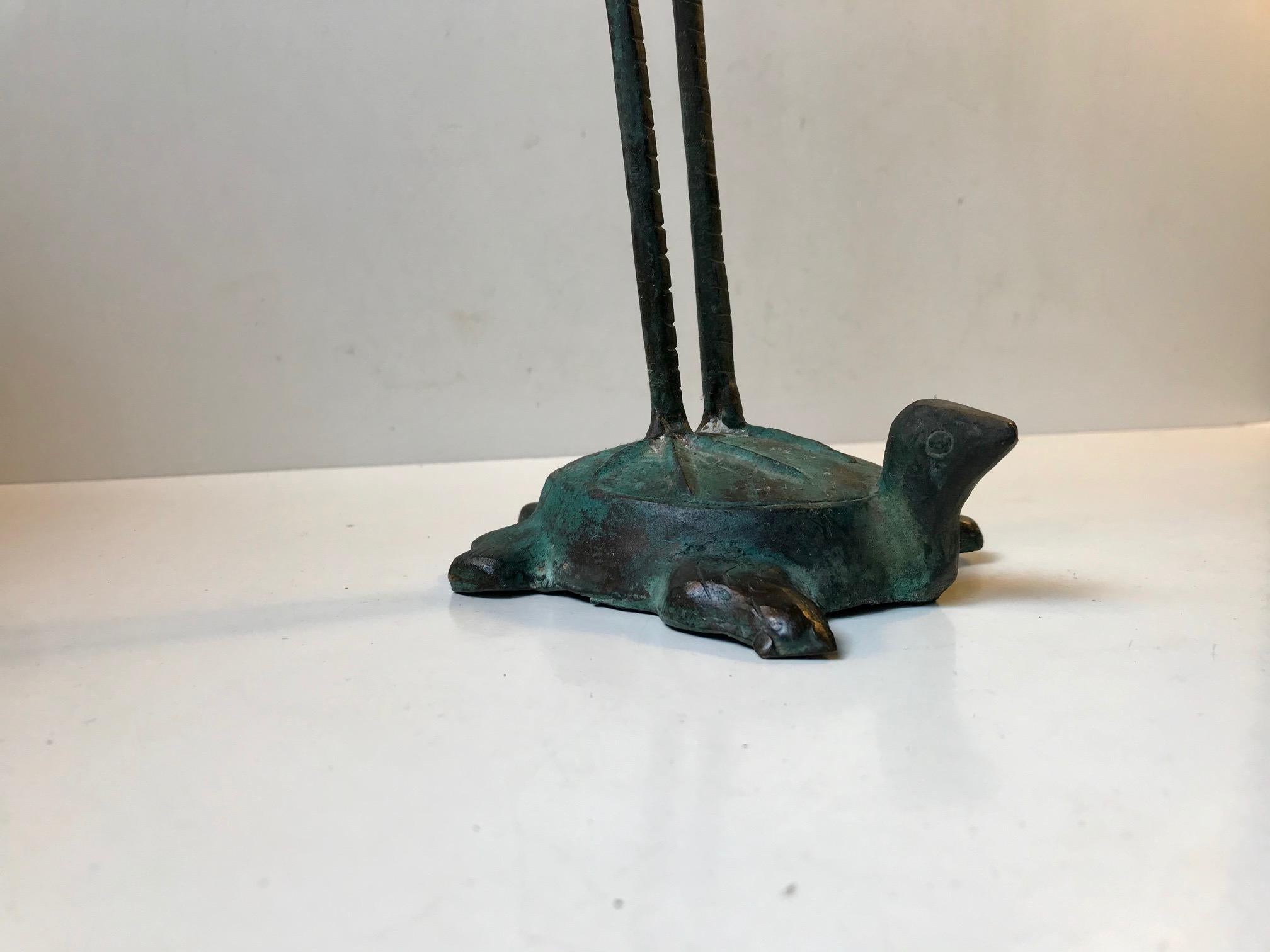 Tall and lean garden ornament in shape of this patinated 'Crane on a Turtle'. It is vintage and made to imitate much earlier Chinese pieces. This piece dates from circa 1970-1980.