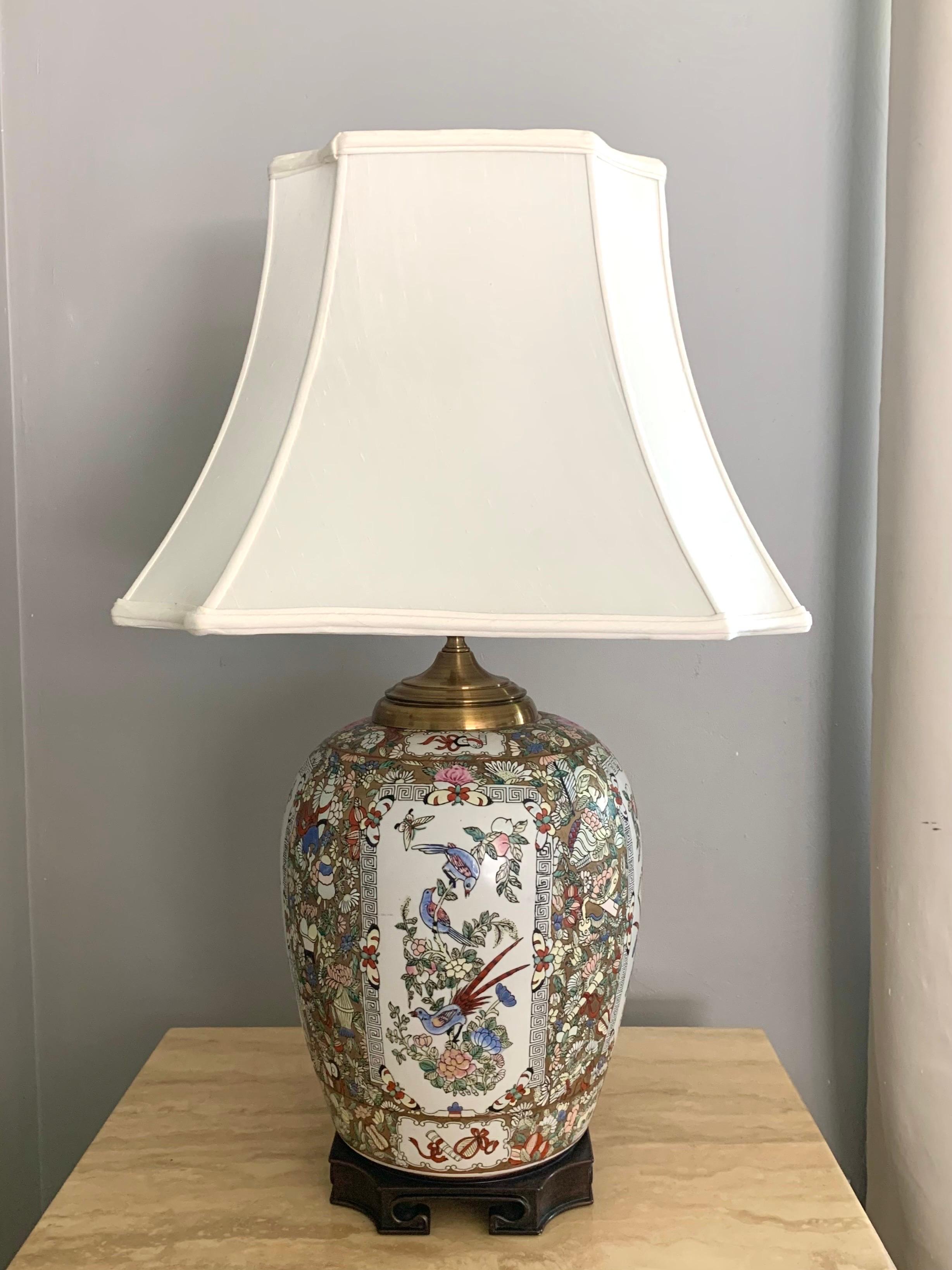 A beautifully detailed hand painted vintage Chinese ginger jar that has been converted to a lamp. With a white and gold colored background that allows the vibrancy of the detailed art and colors to jump off the lamp. Four near identical panels on