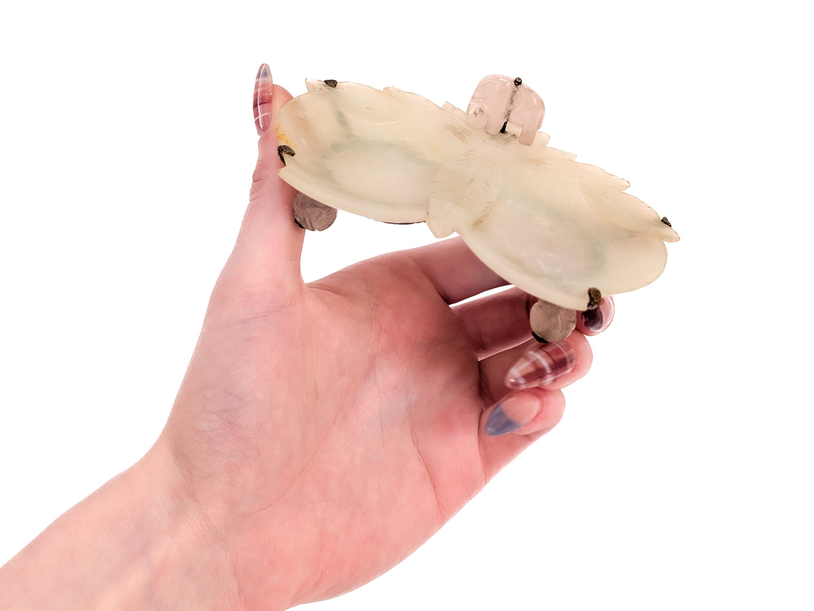 A fine Chinese carved quartz decorative dish or vide poche. 

The pale green quartz bowl carved in a foliage and fruit form, with the two bowls in the form of two pieces of 2 plums.

With pink quartz accents in the form of a screw mounted elephant