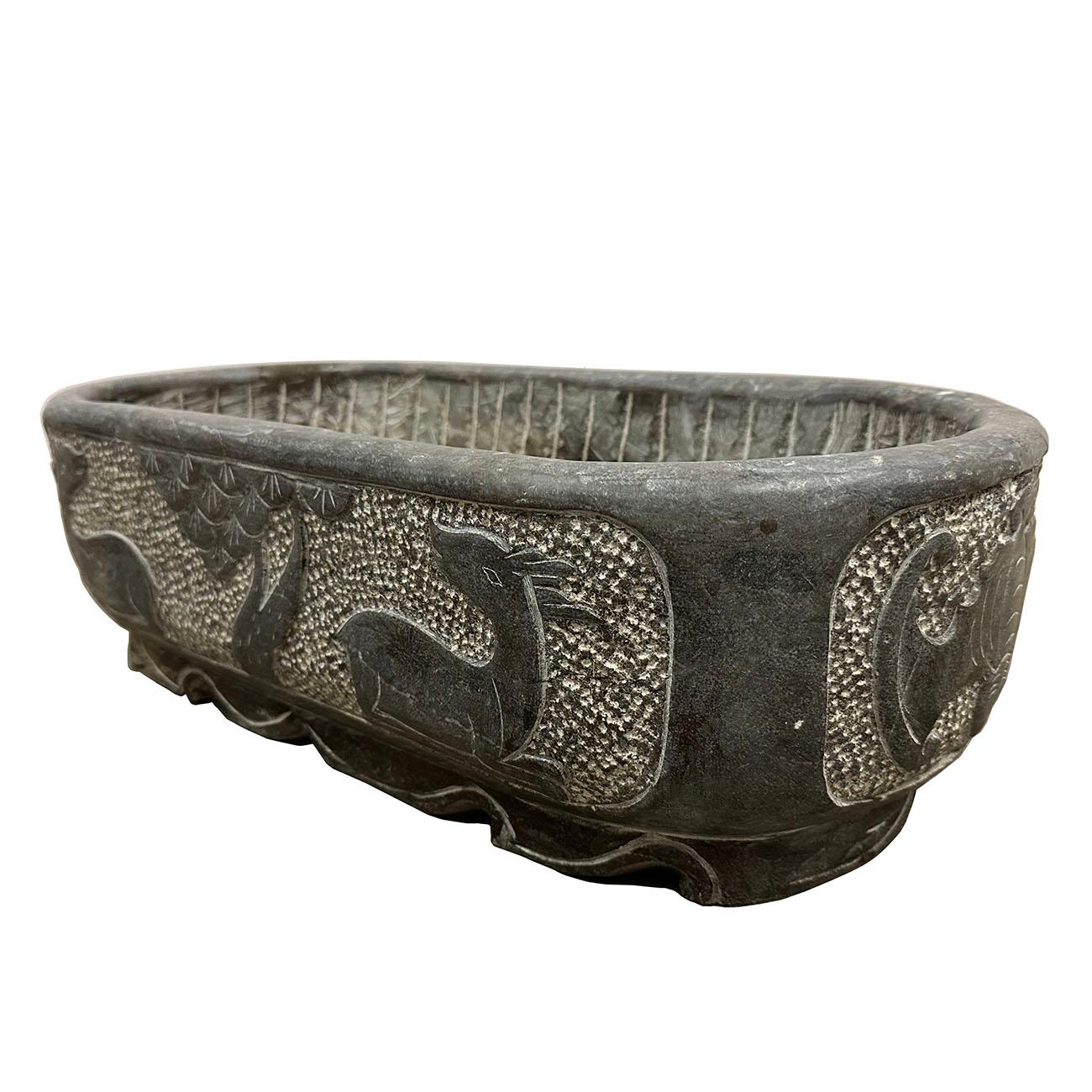 This stone planter is retrieved from the village in northern part of China. It is hand chiseled out of one piece of stone and hand carved by the local stone master. It's originally for feeding chicken, ducks, etc. Now It can be an unique garden