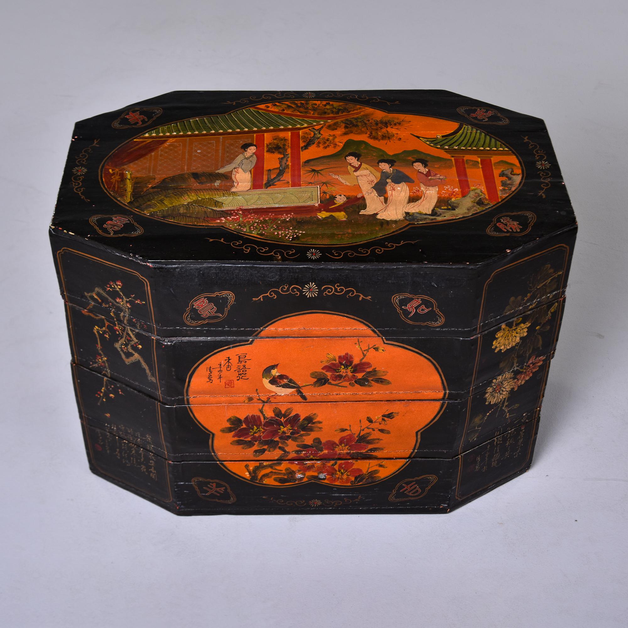 Circa 1940s Chinese export eight sided, four section stacked box. Thin, lightweight wood-constructed box covered in canvas, hand-painted on top, front, back and sides and sealed with lacquer or varnish. Black with gold and red/orange traditional