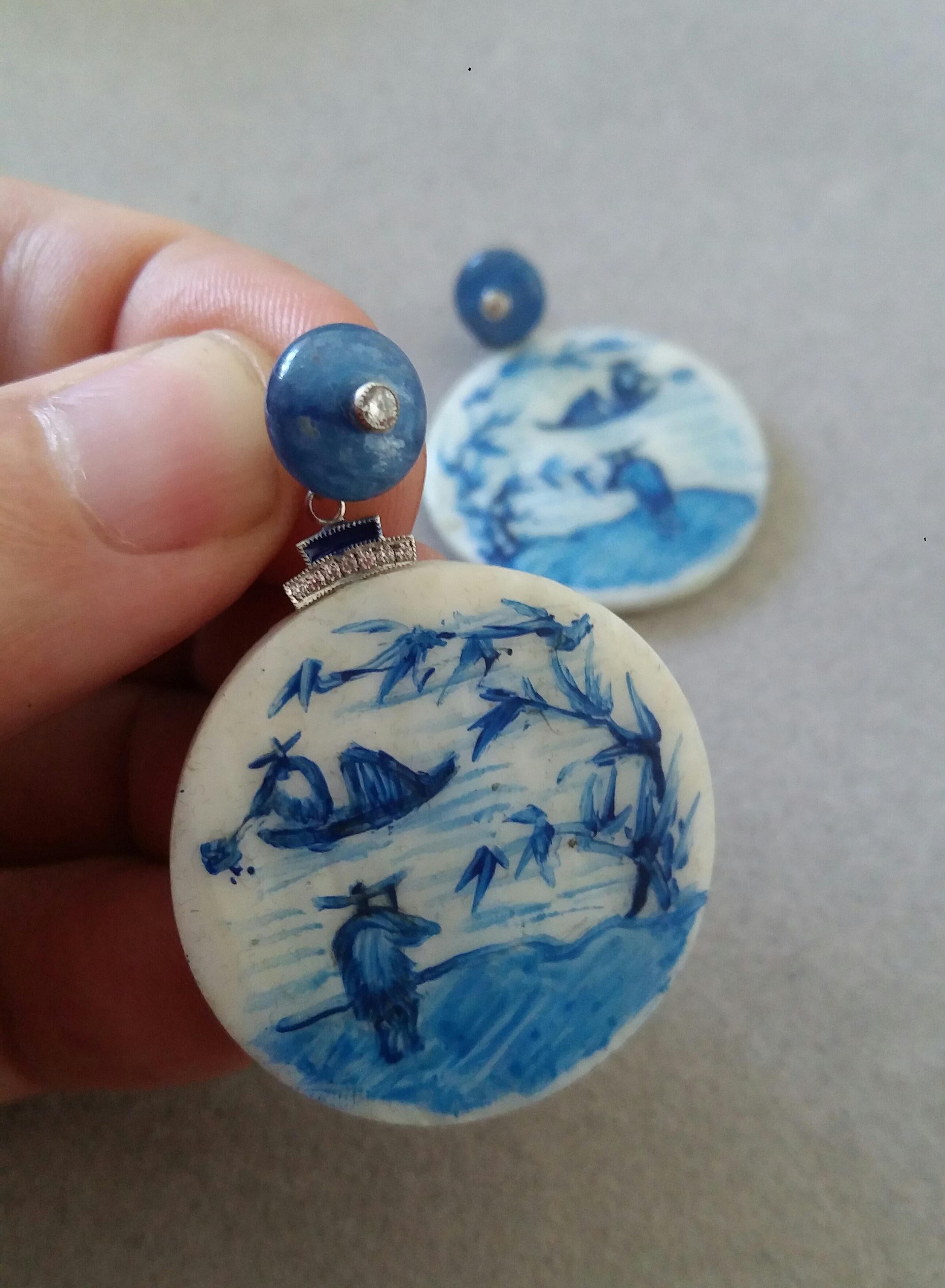 Vintage pair of round shape hand painted Mother of Pearl  discs depicting  a chinese landscape,2 fishermen and a boat on the river ,suspended from 2 Kyanite round buttons of 10 mm with a diamond set in the center,in the middle we have 2 white gold