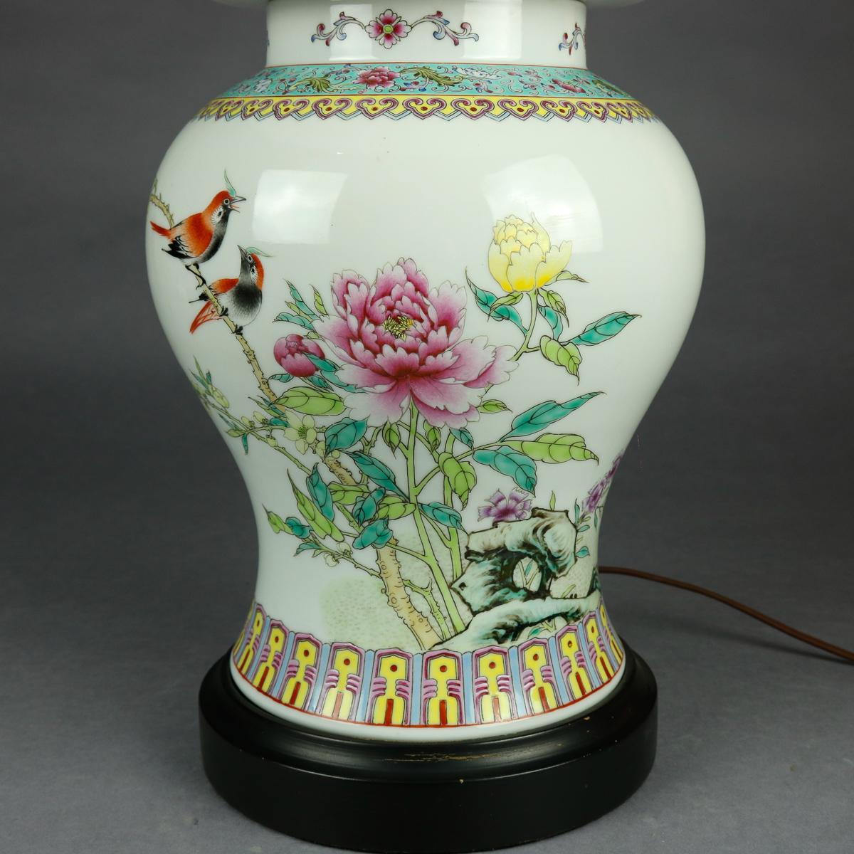 A vintage Chinese table lamp offers lidded porcelain ginger jar in hourglass form with hand painted garden scene of flowers and birds, collar with repeating stylized foliate pattern, en verso with chop mark verbiage, seated on hardwood base, 20th