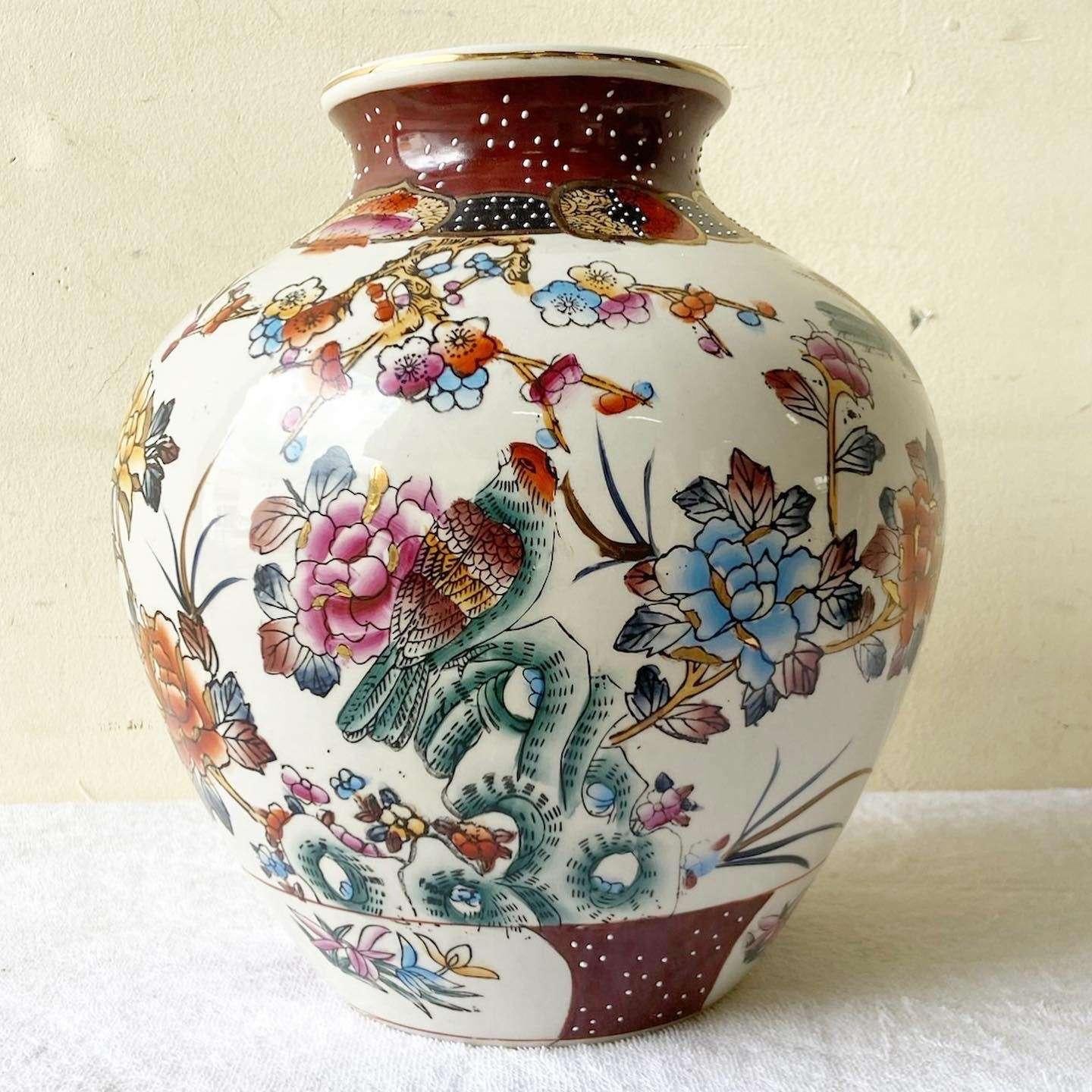 Amazing vintage Chinese hand painted vase. Features flared flowers with foliage through the exterior of the vase.
