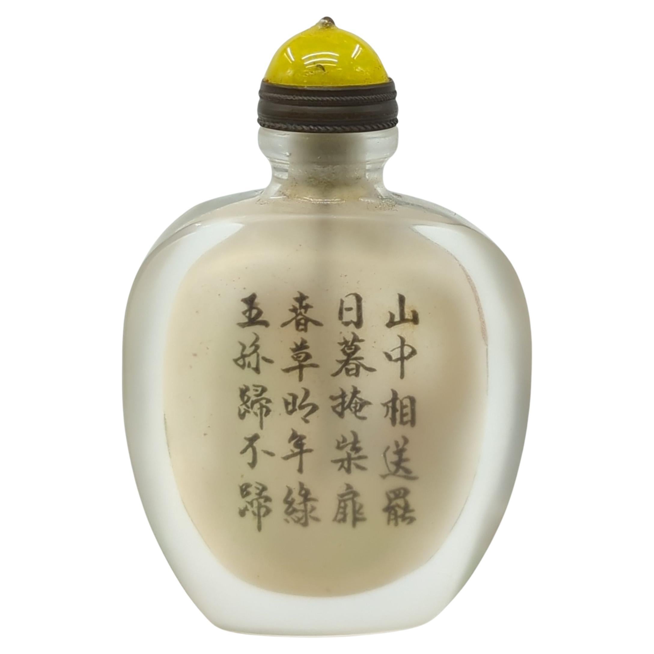 A vintage Chinese inside painted glass snuff bottle, hand painted with figures  below a pine tree to one side, and poetic versus in calligraphy to verso

The finely painted figural scene is accompanied by the text  