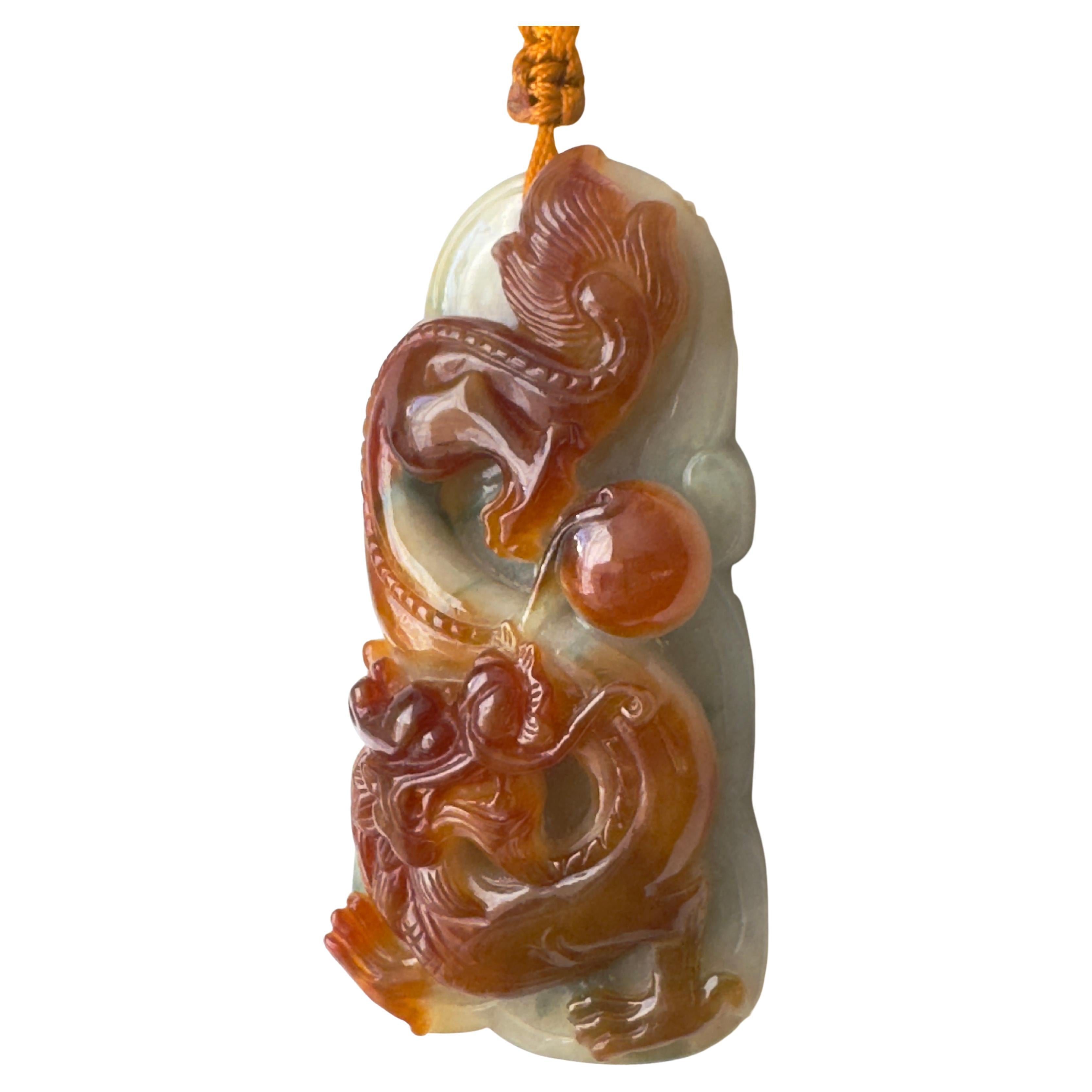 Vintage Chinese Carved Red Jade Jadeite Dragon Pendant 
Hand carved natural Red jadeite pendant with Chinese Dragon from light green and gray to red  color. 
About 2.50 inch long and little over 1.25 wide it weight about 45.98 grams. Presented on a