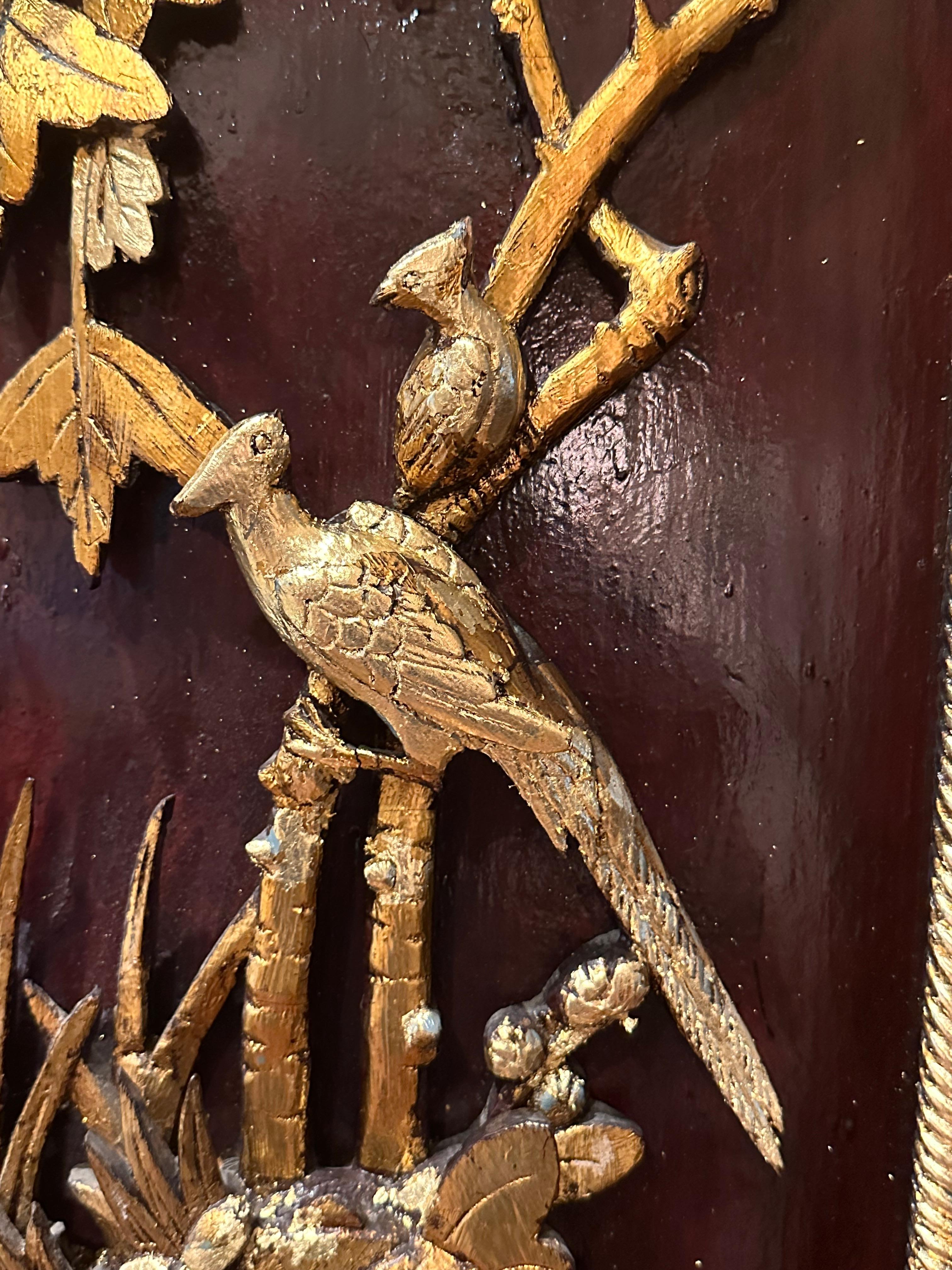 Vintage Chinese Large Hand Carved and Gilded Wood Panel

Elaborate and deeply carved wood panel dates from the end of the 19th century. The dark burgundy red lacquered background has an inner carved giltwood faux rope frame. Two paradise birds perch