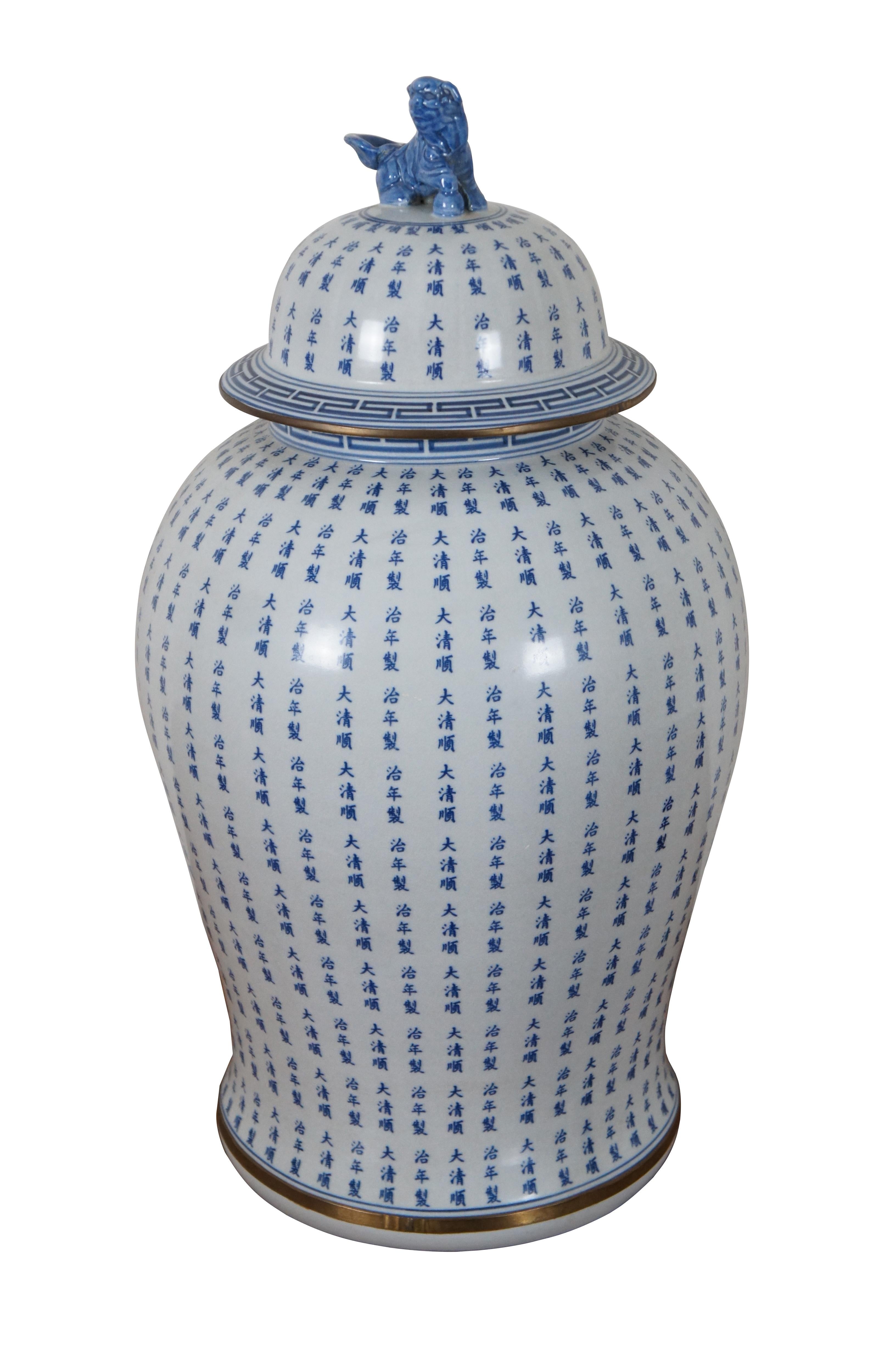 An impressive 20th century blue and white porcelain Chinese export Qing dynansty marked ginger jar. Features a body covered in calligraphy with gold accents and figural foo dog or lion finial lid.