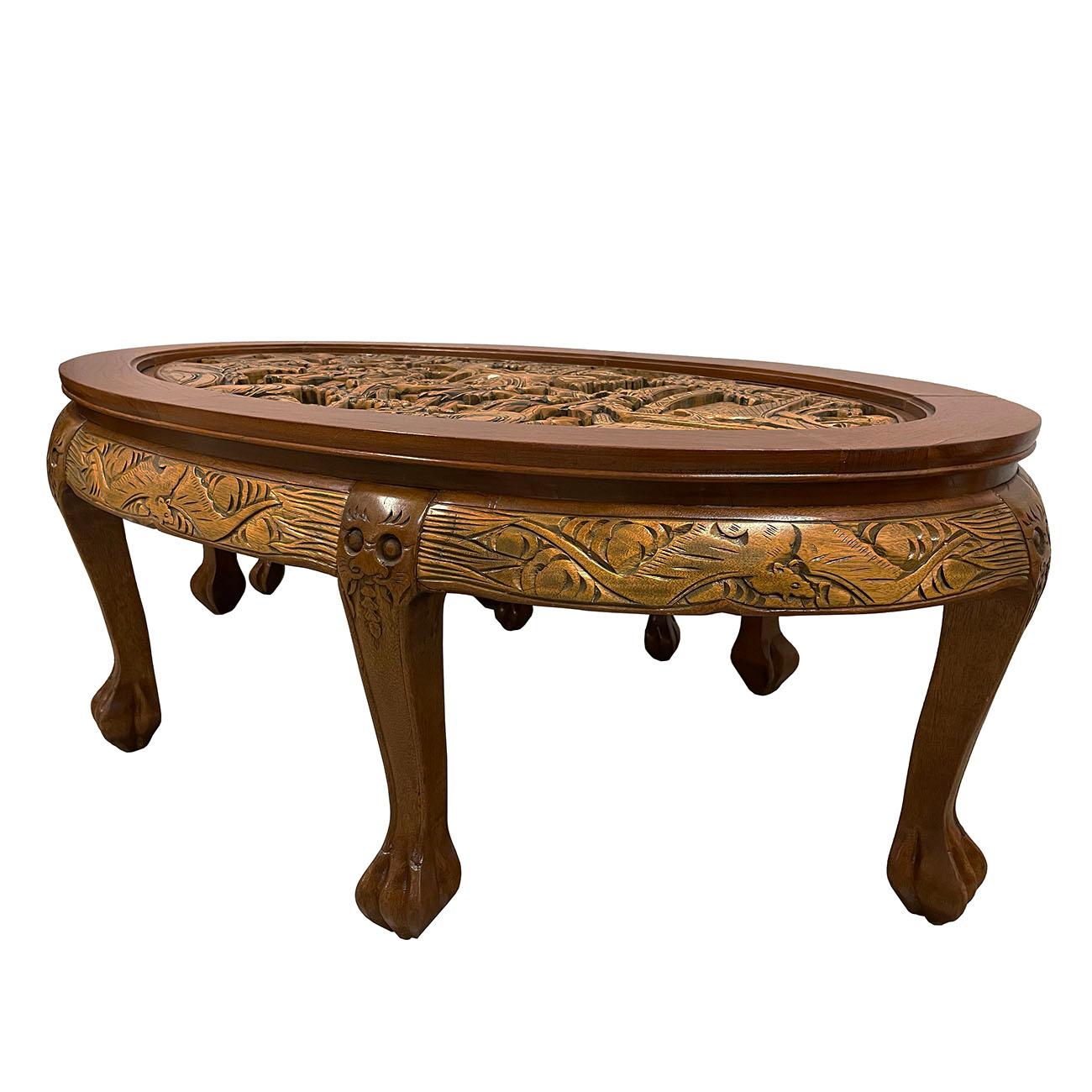 This beautiful carved coffee table from the early 1900s is made from solid Teak wood and showcases the beautiful details of Chinese traditional massive carving works of Chinese beauties on top surface and protected by a custom made glass cover.