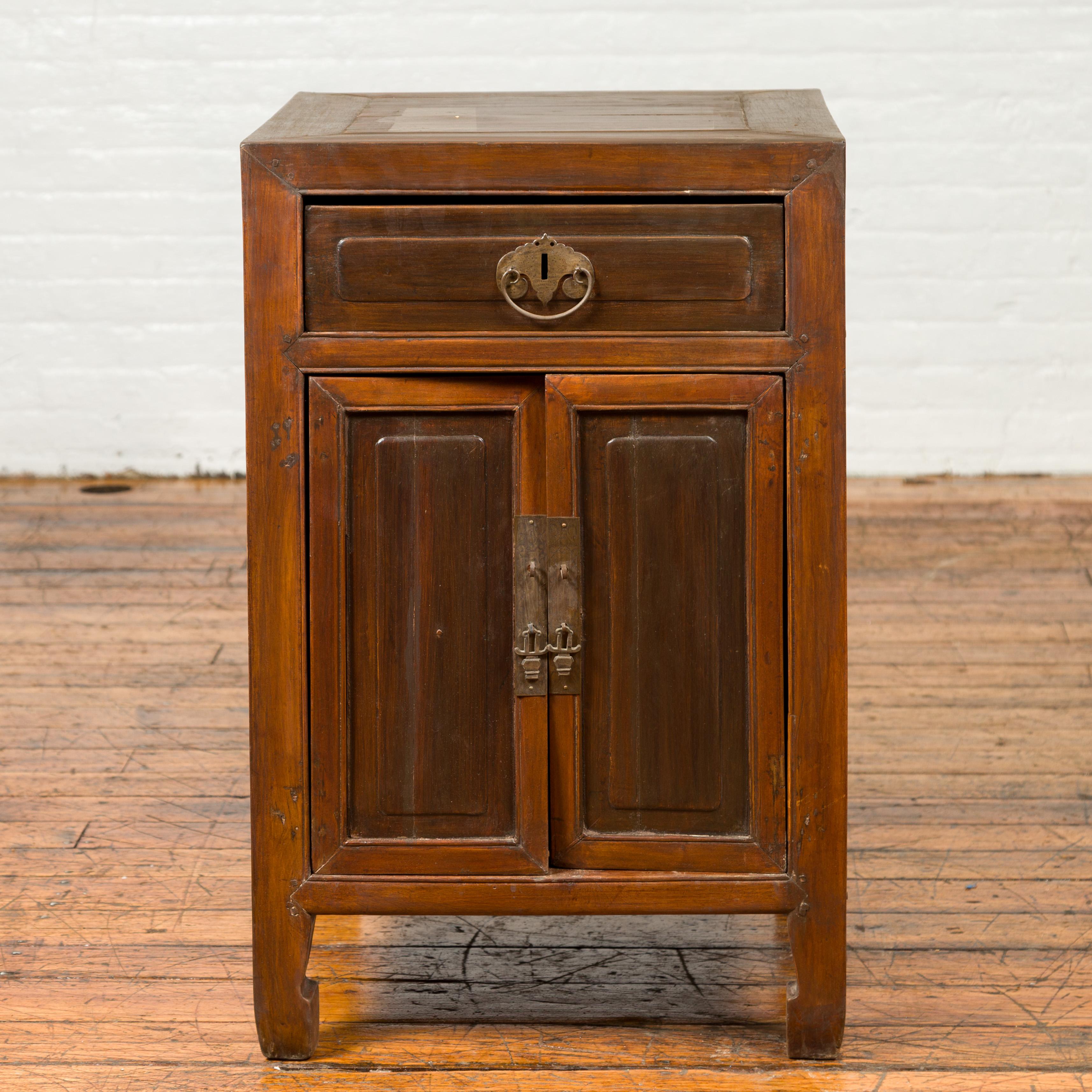 A vintage side chest from the mid-20th century, with horse hoof feet and two-toned finish. This mid-century vintage side chest exemplifies a blend of functionality and aesthetic charm. Crafted during the mid-20th century, this piece features a