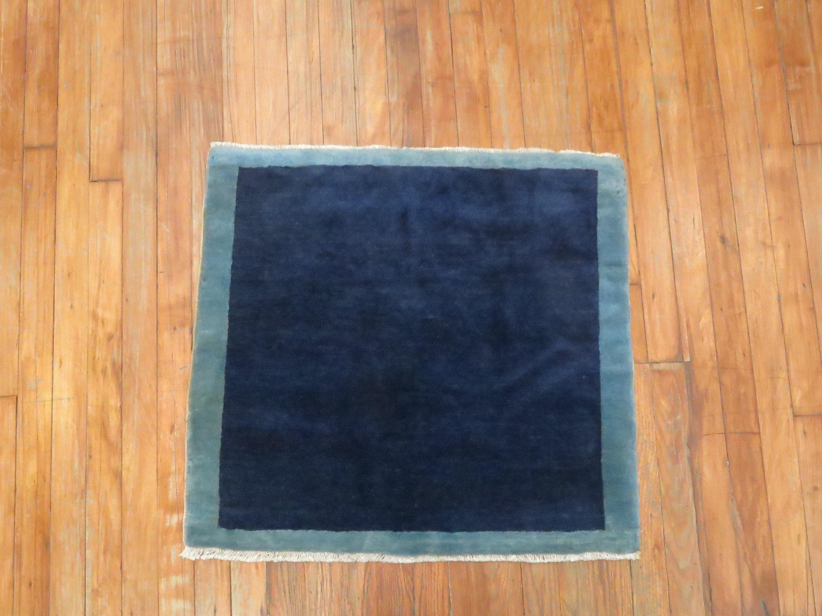 A minimalist one-of-a-kind vintage Chinese rug in blues.

Measures: 2'3'' x 2'5''.