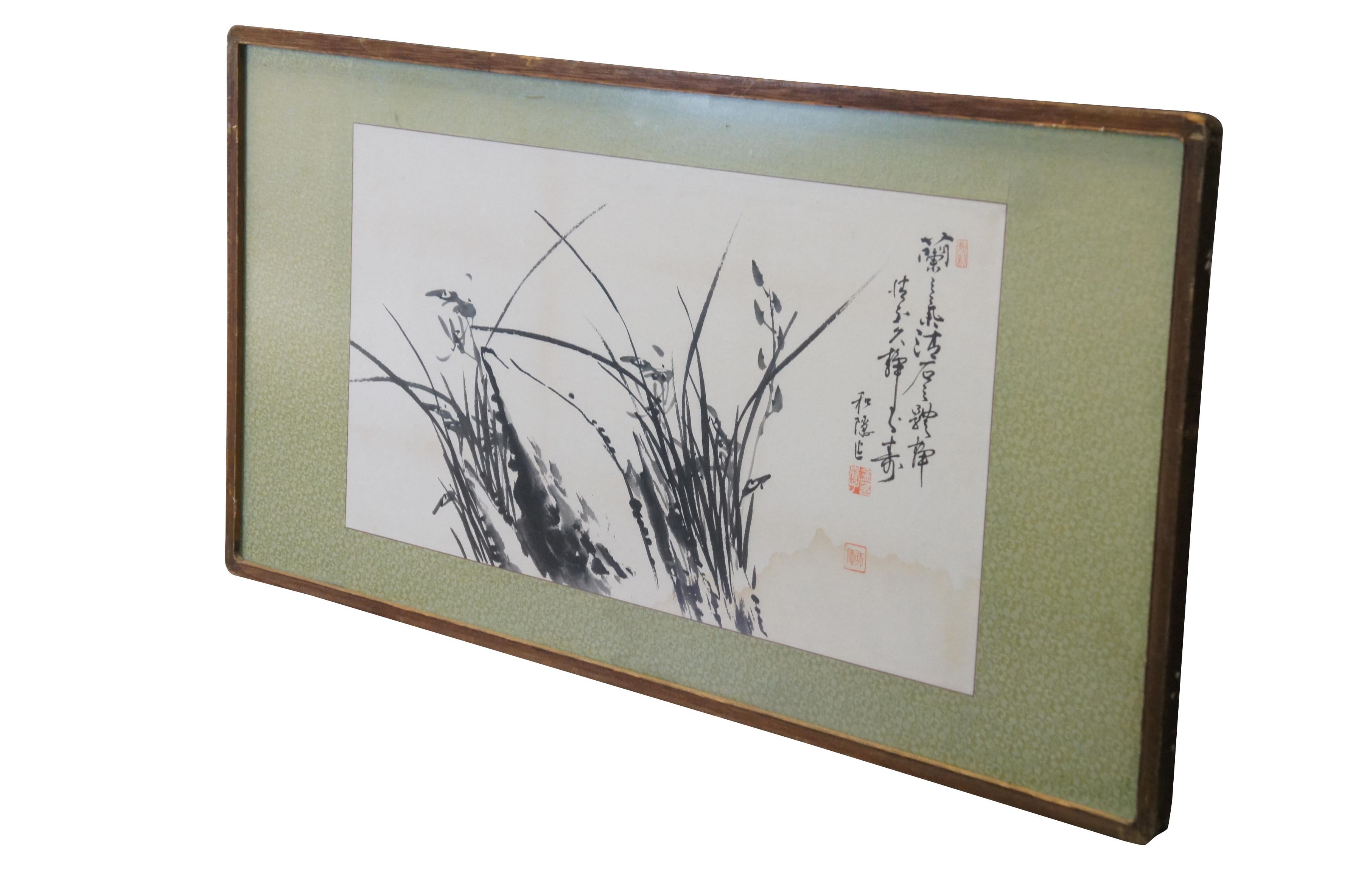 Mid to late 20th century Chinese poem / painting featuring a landscape of orchid flowers among the long grasses, drawn monochrome in black ink on white scroll paper. Signed and sealed. Plain wood frame; green silk mat. Keystone Picture Frame