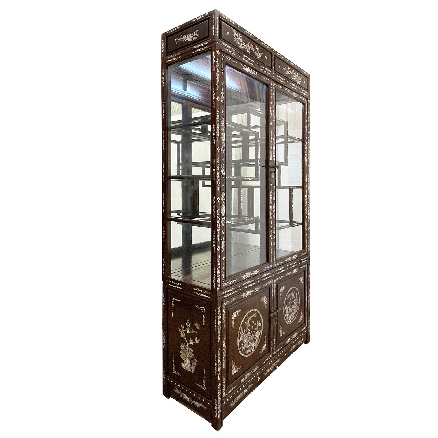 Size: 76in H x 40in W x 14in D
Door opening: Top glass door: 44in H x 37in W
 Bottom wooden door: 18 1/4in H x 37in W
Drawer: 3 1/2in H x 16in W x 10in D 
Origin: China
Circa: 1900 - 1940
Material: Rosewood with Mother of Pearl