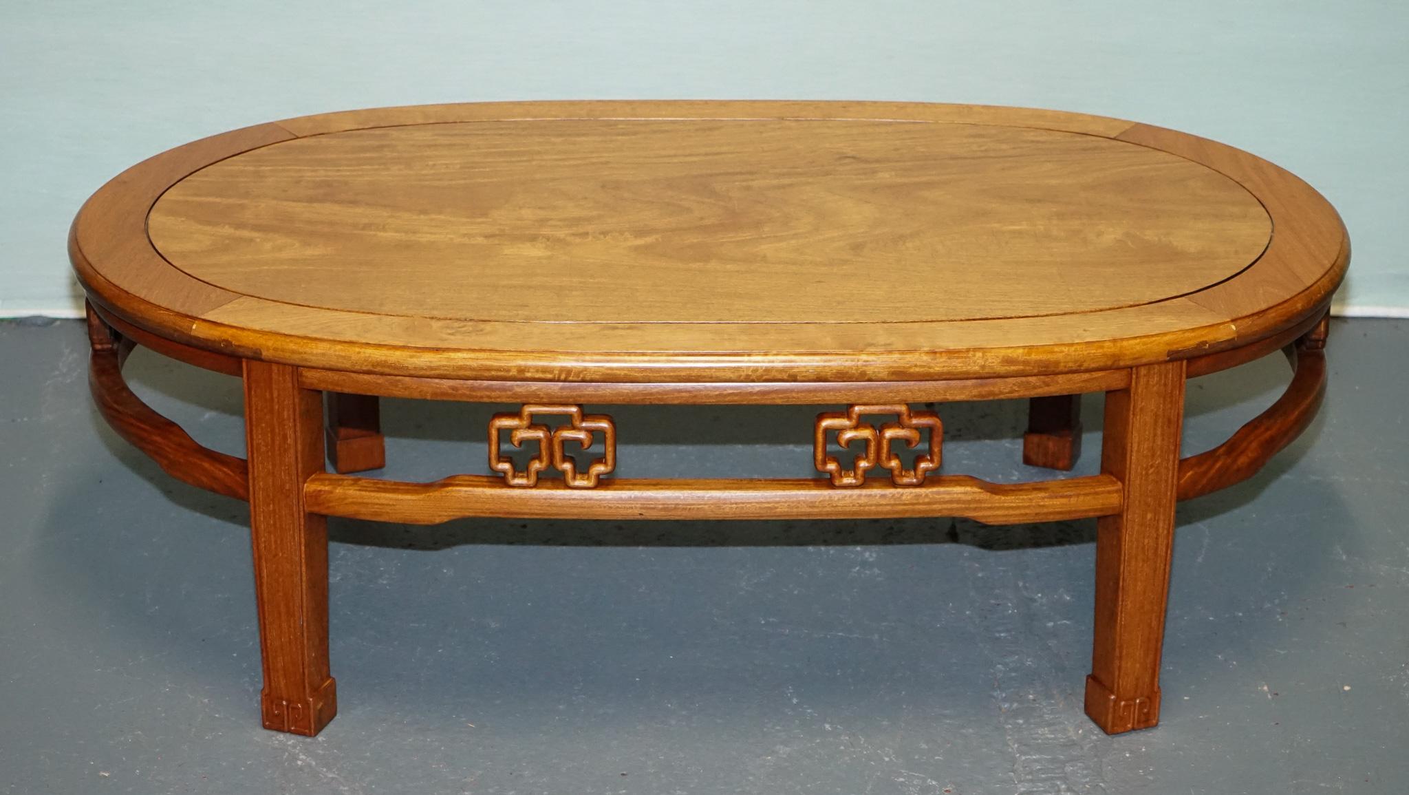 
Antiques of London



This is a vintage Chinese oriental teak coffee table, likely dating from the mid to late 20th century. The table showcases a beautifully grained oval top with a slightly raised edge banding and a refined inlaid border, giving