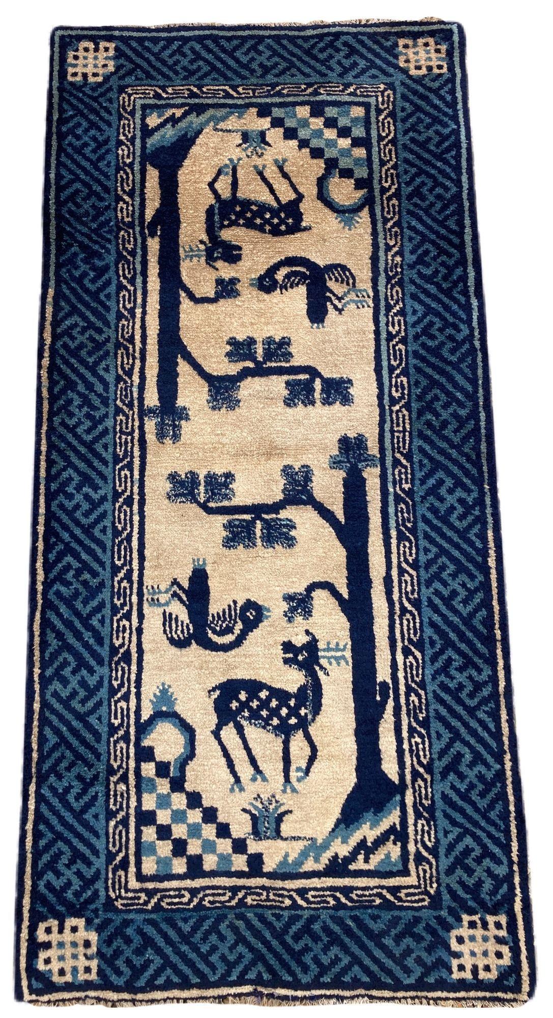 A lovely vintage Pao-Tao rug, handwoven in China circa 1940 with the traditional design of the deer and the crane on an ivory field and dark indigo key border.
Size: 1.20m x 0.58m (3ft 11in x 1ft 10in)
This rug is in good condition with light age