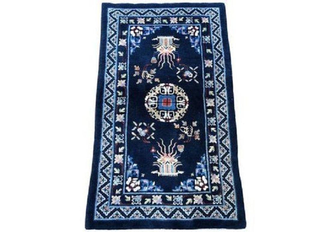 A beautiful Pao-Tao rug, handwoven in China circa 1940 with a single medallion design on a navy blue field and secondary colours of ivory, light blue and reds.
Size: 1.64m x 0.96m (5ft 5in x 3ft 2in)
This rug is in original condition with good pile