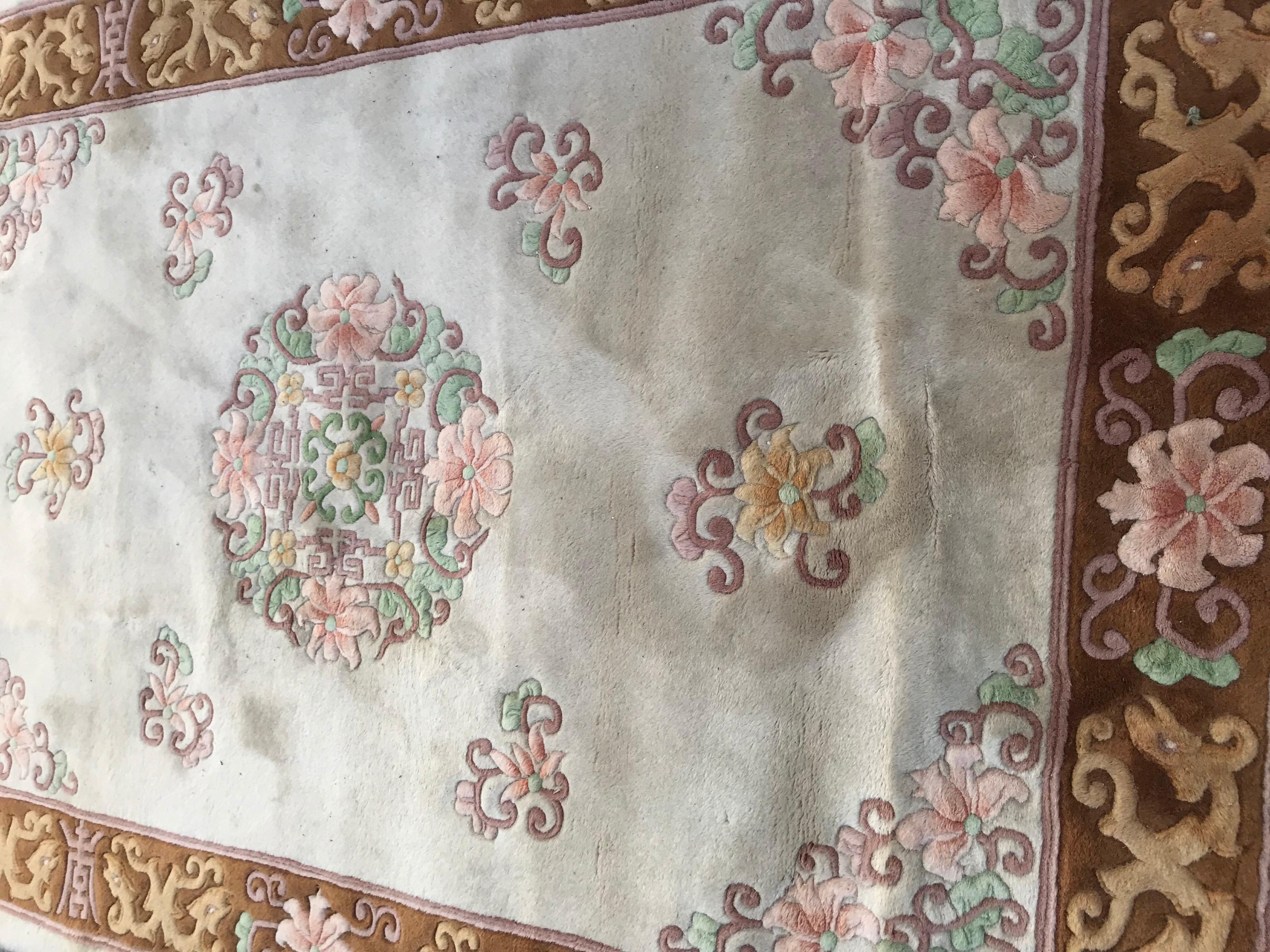 Beautiful late 20th century Chinese rug with light colors with beige, brown, green, yellow and pink, and Chinese design, entirely hand knotted with wool velvet on cotton foundations.