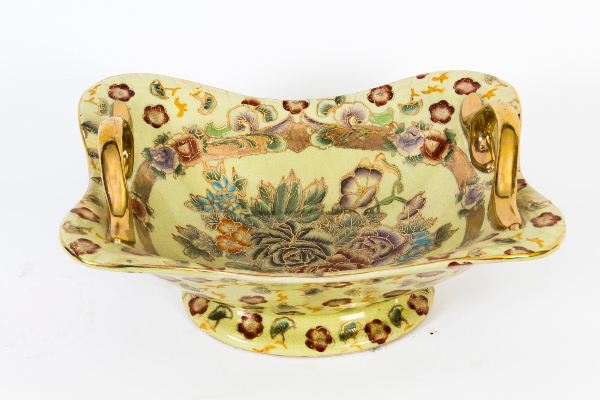 This is a lovely porcelain bowl, mid-20th century in date.
 
The shaped oval bowl features a pair of gilt handles and is beautifully painted with a cream ground and brightly coloured roses with gilt highlights.
 
Add this beautiful dish to your