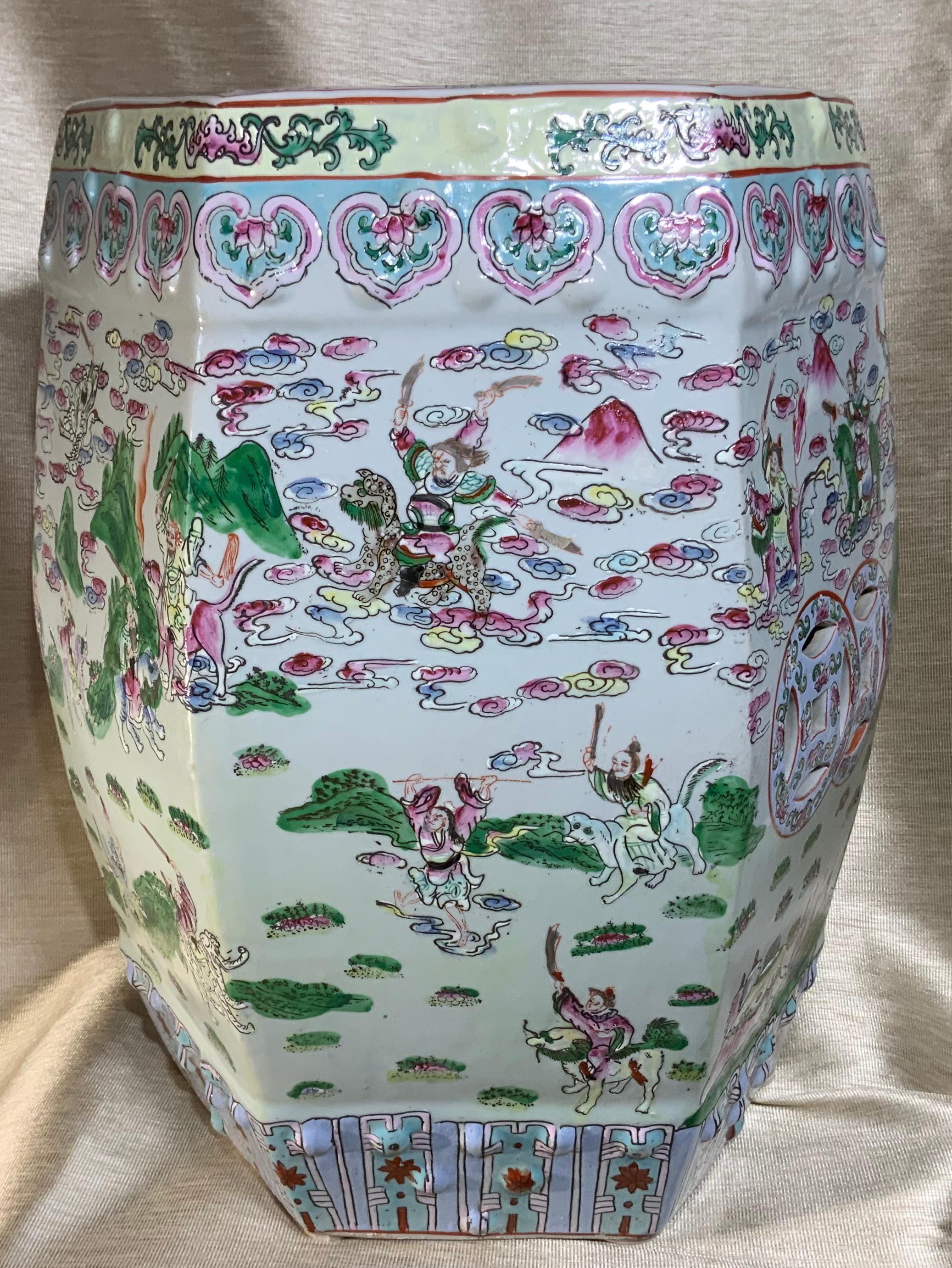 Beautiful Chinese porcelain garden stool of traditional drum shape, stunning colors of light blue lime, light turquoise and green of Chinese scenery of war, garden and landscapes. All around at six sides. The top is with cutout of a single Chinese