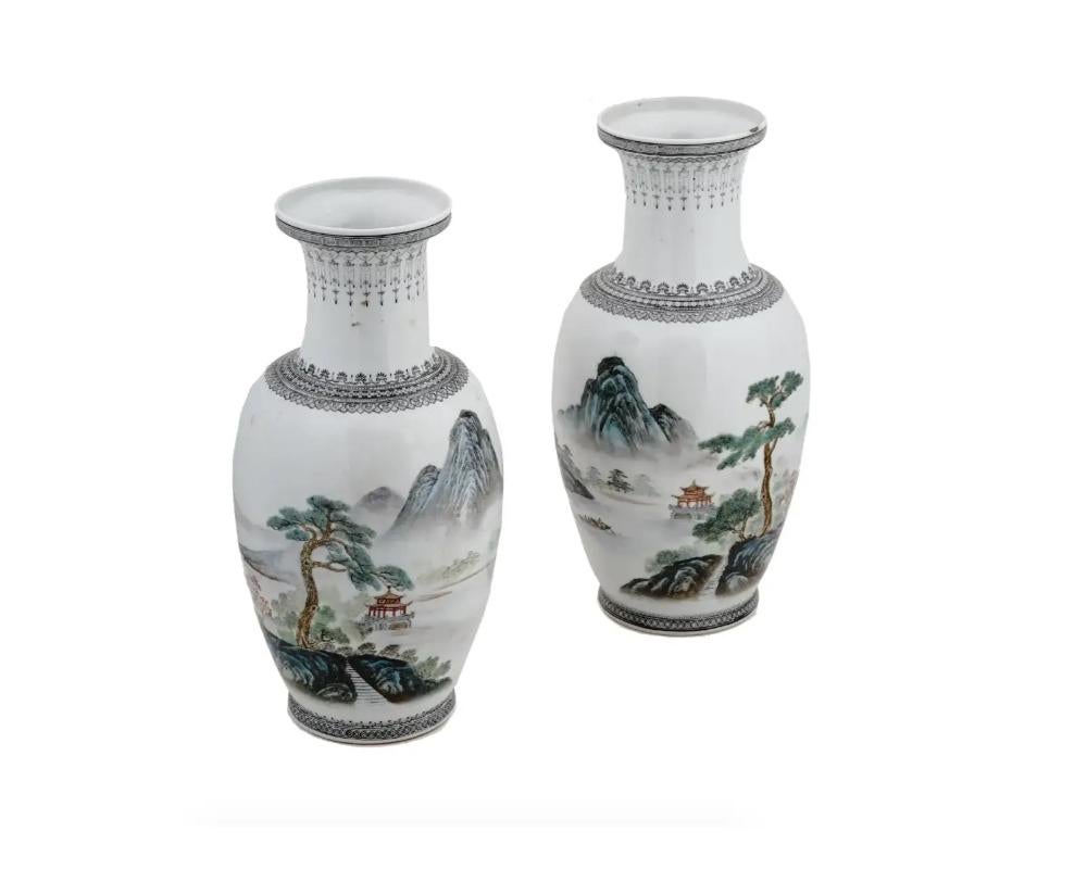 A pair of matching mid-20th century Chinese porcelain vases. After 1949. White pieces with ornamentally decorated neck and base in black. The bodies are garnished with mountain landscapes on the obverse and poems from the Siku Quanshu on the