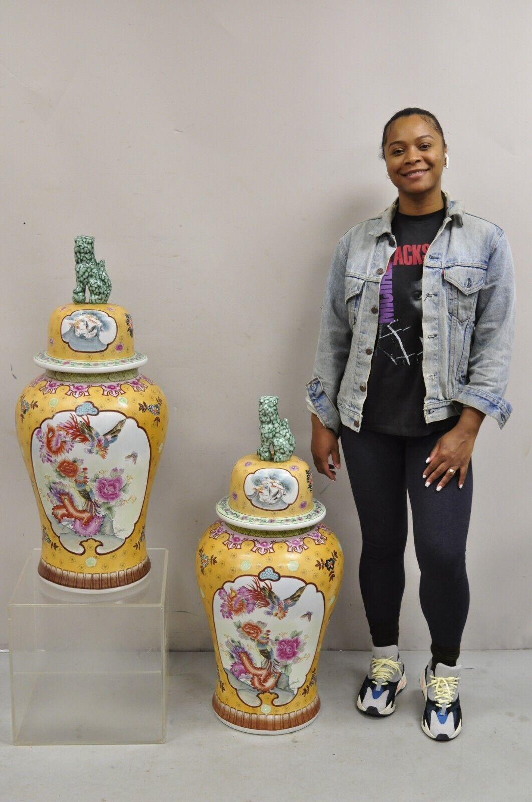 Vintage Chinese Porcelain Large Foo Dog Covered Temple Jar Ginger Jars - a Pair. Item features Bird, butterfly, and floral decoration on both sides, lid with green foo dog handle, large impressive size. Circa ex Late 20th Century. Measurements: 36