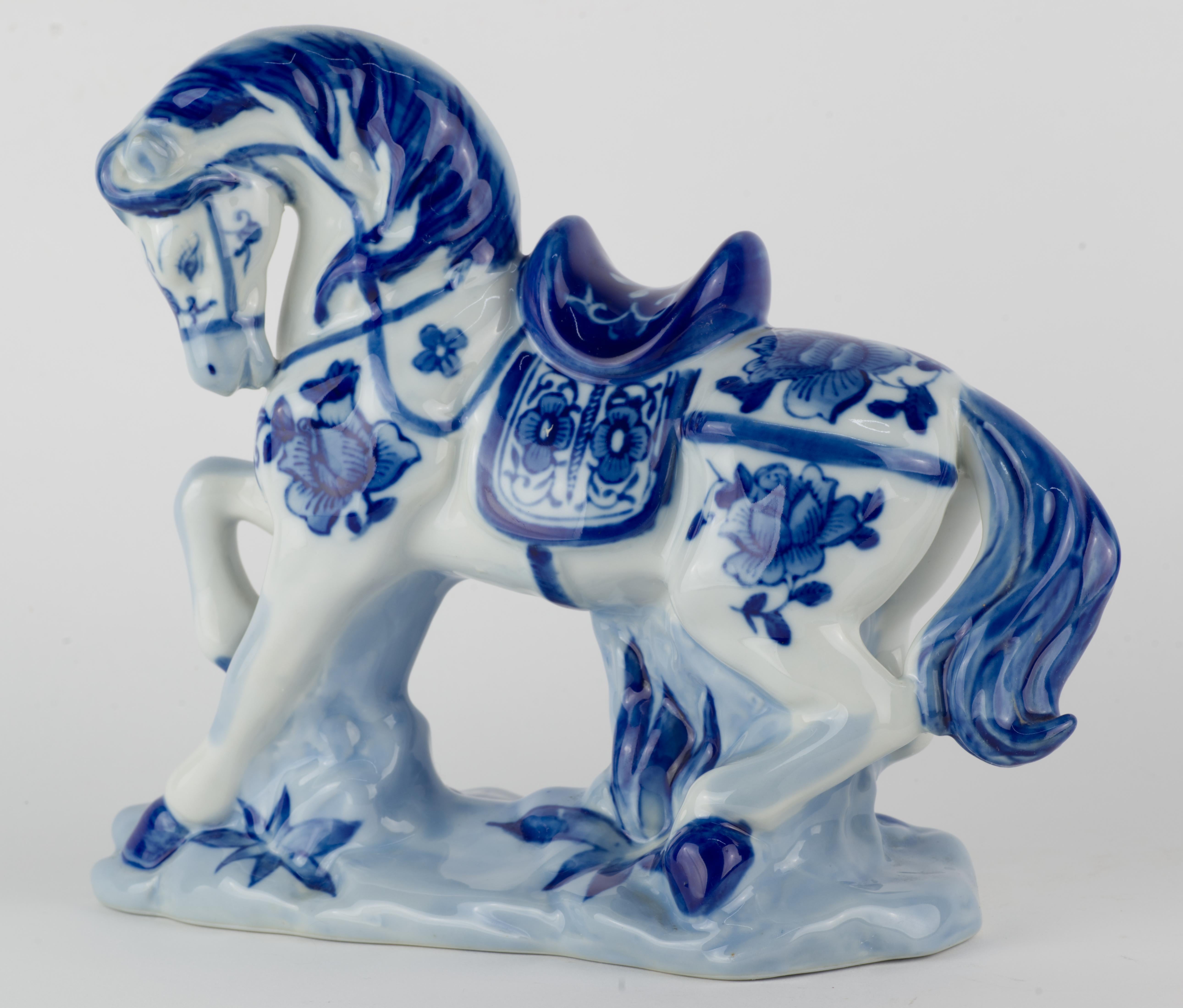  Highly detailed vintage figurine of a saddled horse in motion is hand decorated with abstract flower motifs; the decor is done in traditional blue and white palette.

The heavy, substantial figurine stands 8.5