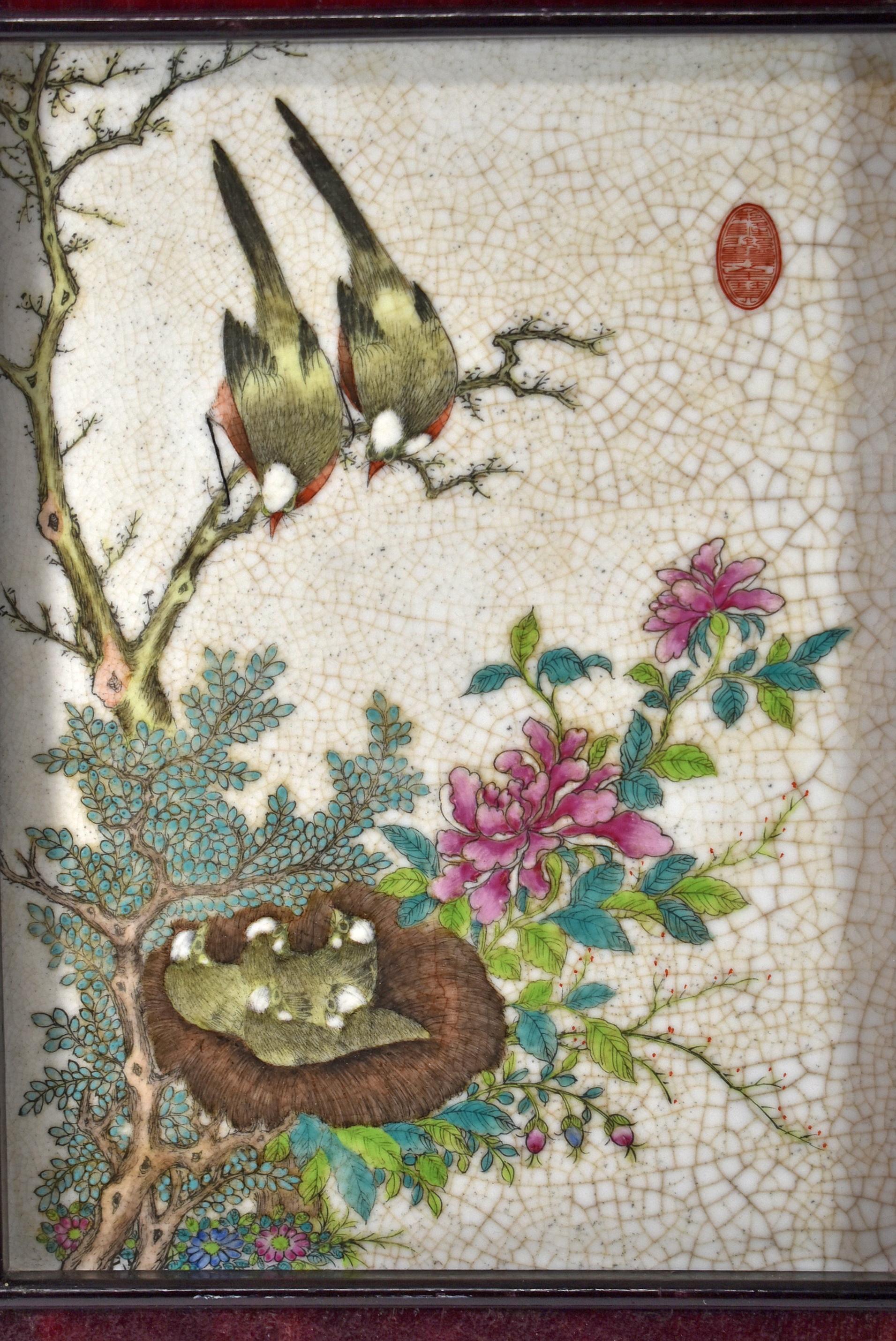 Vintage Chinese Porcelain Wall Art Plaque Framed and Signed. circa 20th century. Two birds looking down at a nest of fledglings in a tree. The tree has aqua flowers with aqua and bright green leaves. The tree also has pink flowers and pink and blue