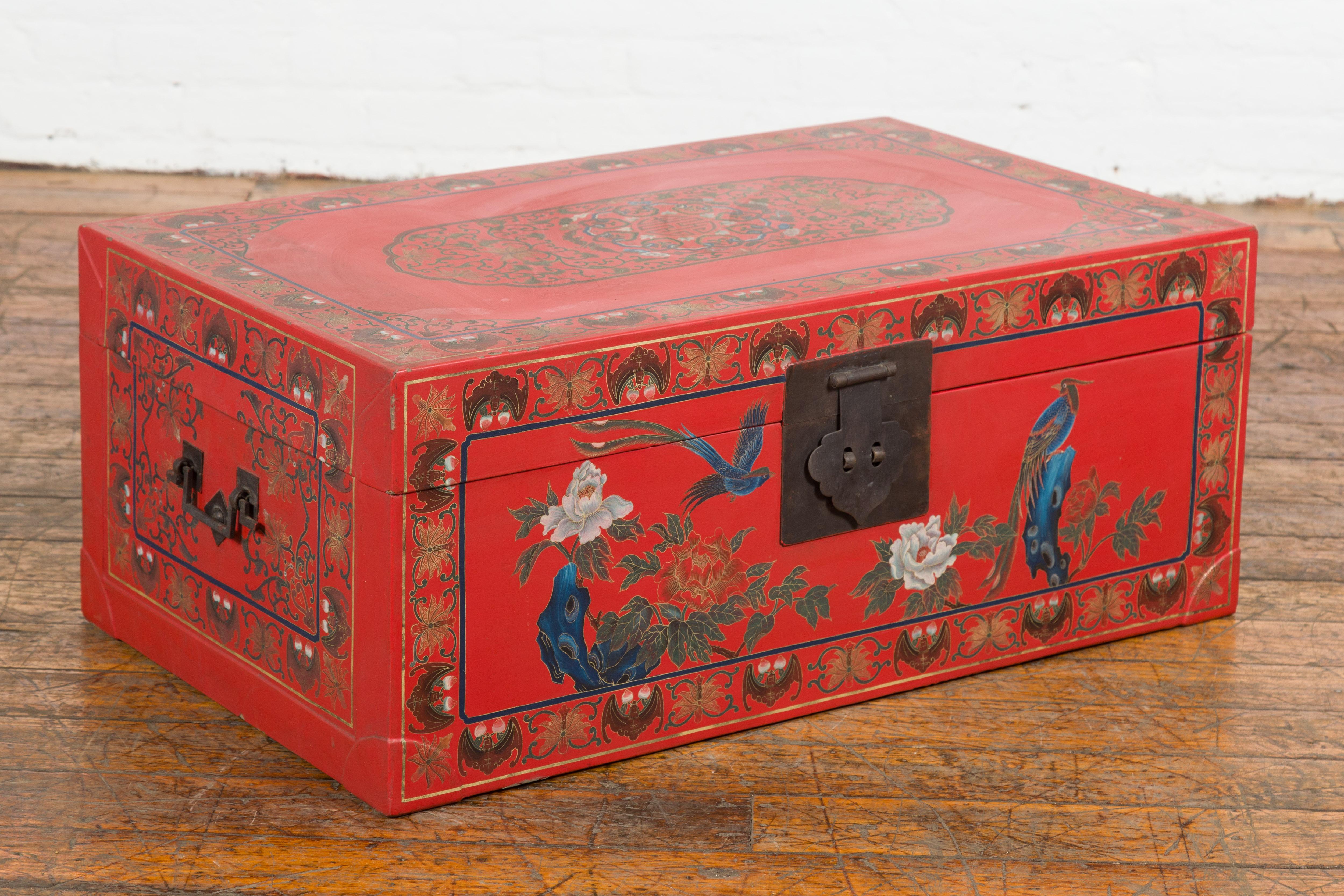 A vintage Chinese red lacquer blanket chest from the Mid-20th Century with egret bird motifs and friezes of bats and flowers around all the edges. Immerse yourself in the artful allure of this vintage Chinese red lacquer blanket chest from the mid